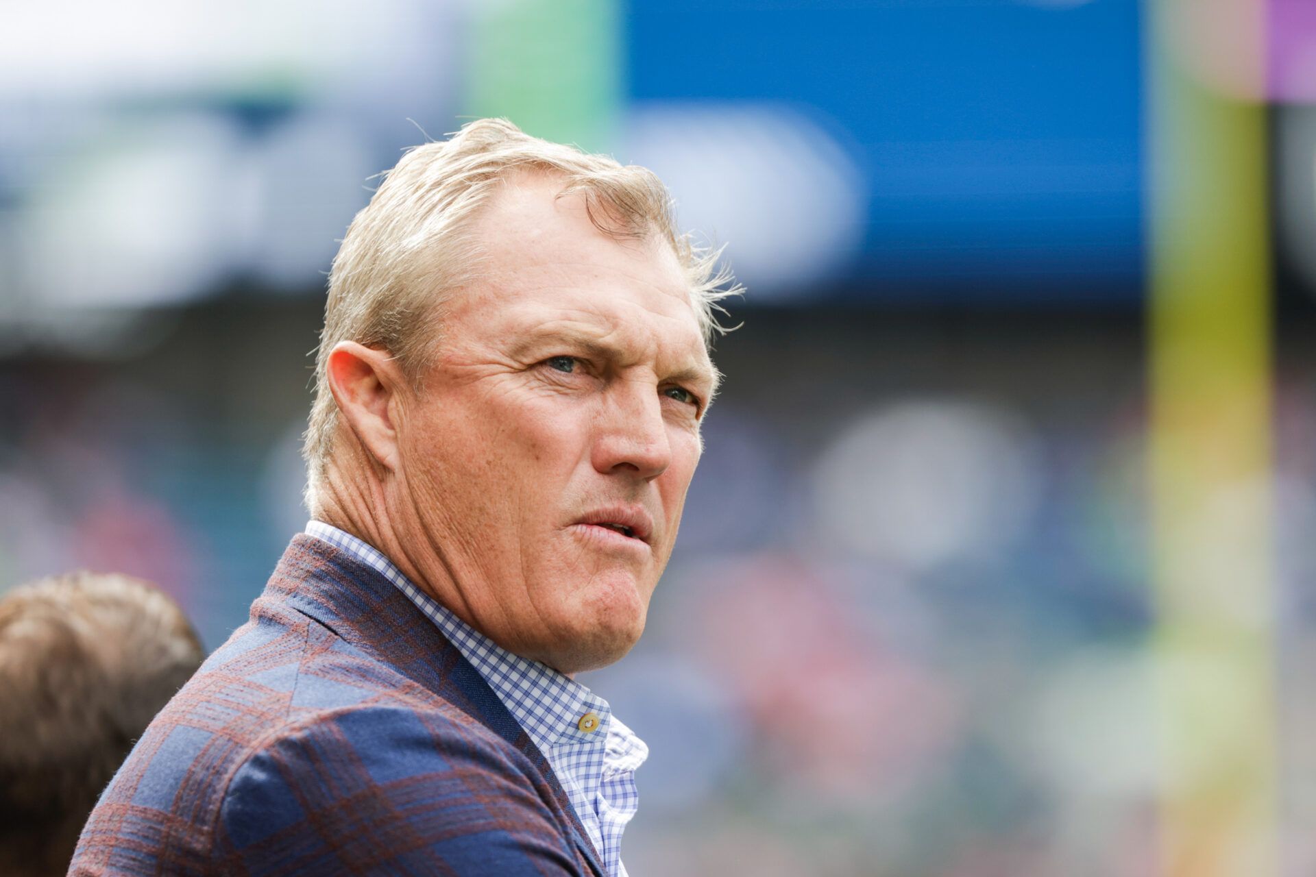 San Francisco 49ers general manager John Lynch watches pregame warmups against the Seattle Seahawks at Lumen Field.