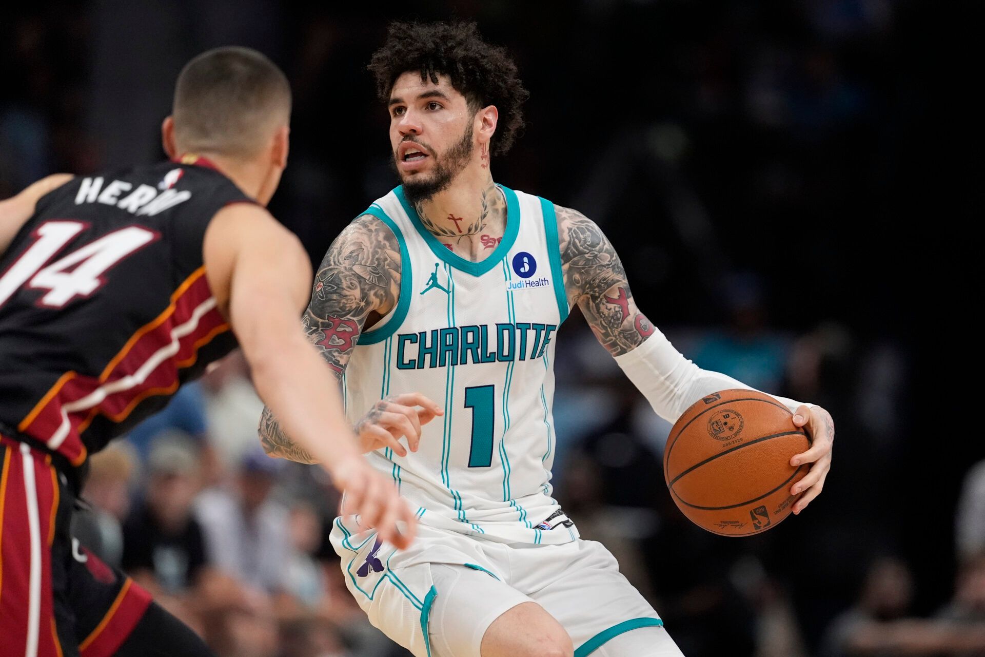 Charlotte Hornets guard LaMelo Ball (1) looks to pass defended by Miami Heat guard Tyler Herro (14) during the second half during the play-in rounds between the Charlotte Hornets and the Miami Heat of the 2026 NBA Playoffs at Spectrum Center.