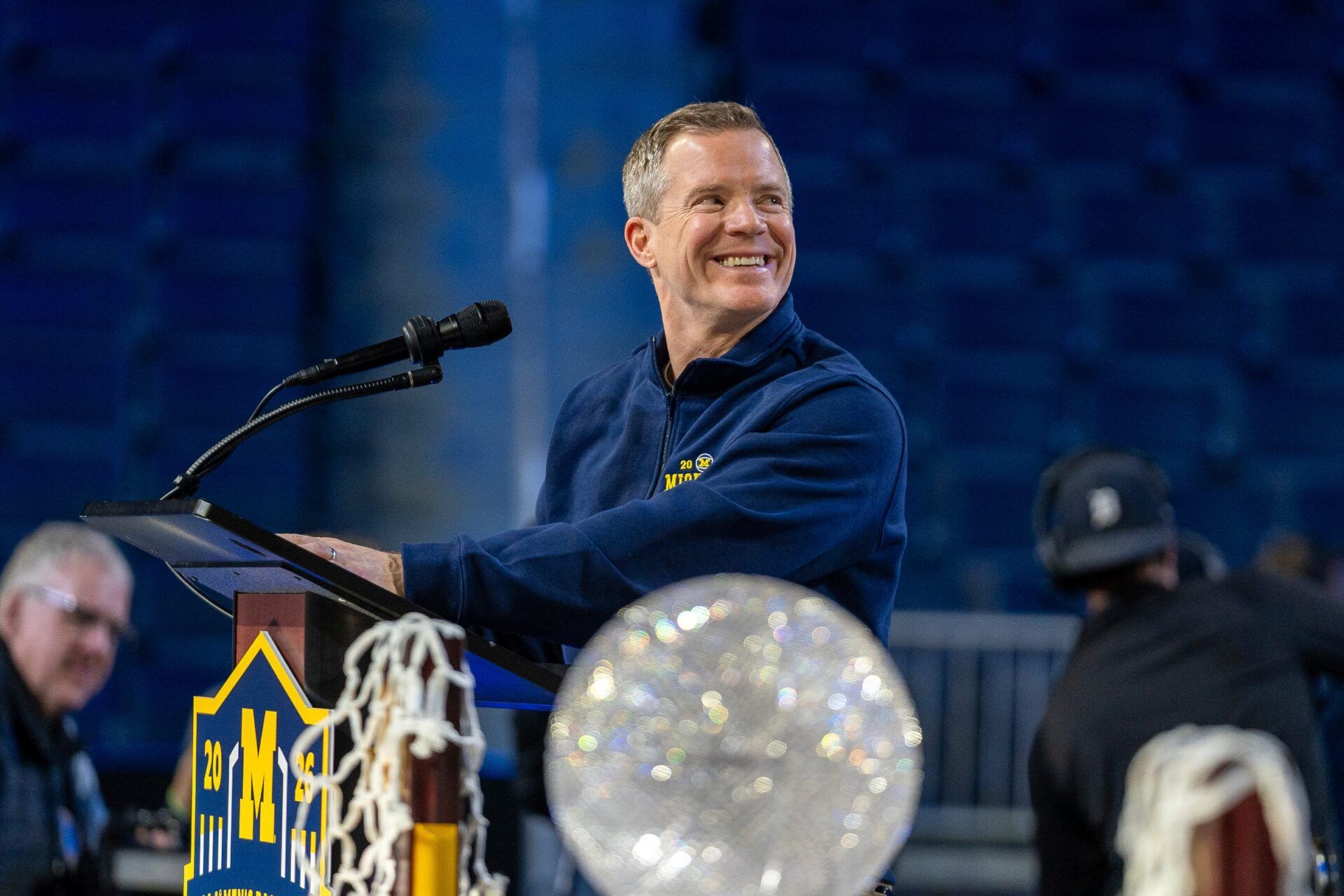 Michigan head coach Dusty May smiles at the podium during a celebration honoring the Wolverines’ NCAA men’s basketball national championship at Crisler Center in Ann Arbor on Saturday, April 11, 2026.