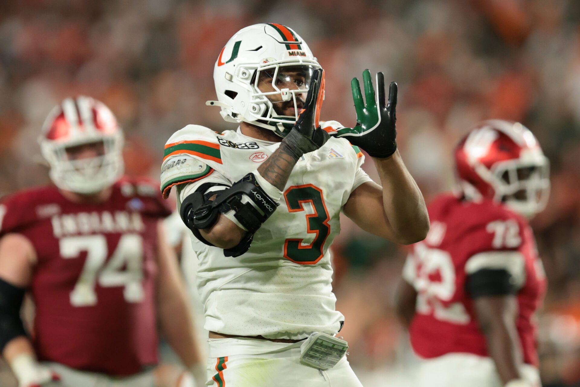 Miami Hurricanes defensive lineman Akheem Mesidor (3) celebrates after a sack against the Indiana Hoosiers in the third quarter during the College Football Playoff National Championship game at Hard Rock Stadium.
