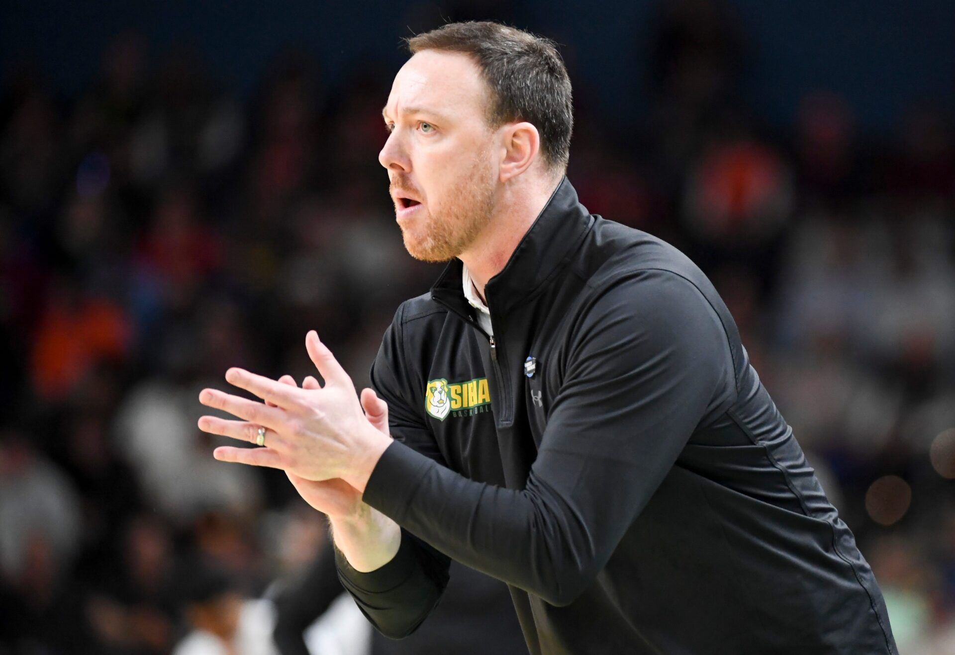 Siena Saints head coach Gerry McNamara claps Thursday, March 19, 2026, during the NCAA Men’s Basketball Tournament first round game against the Duke Blue Devils at Bon Secours Wellness Arena in Greenville, South Carolina.