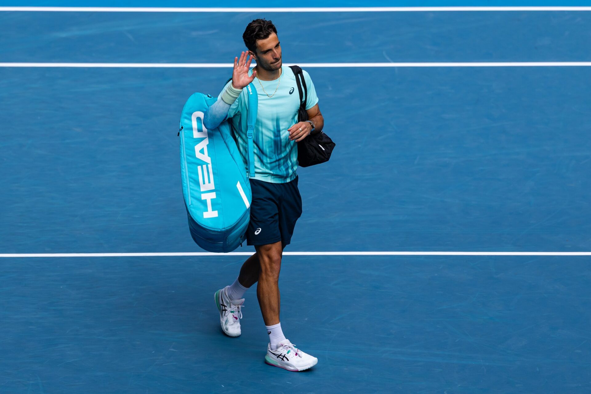Lorenzo Musetti of Italy acknowledges the audience after retiring in his match against Novak Djokovic of Serbia in the quarterfinals of the mens singles at the Australian Open at Rod Laver Arena in Melbourne Park.