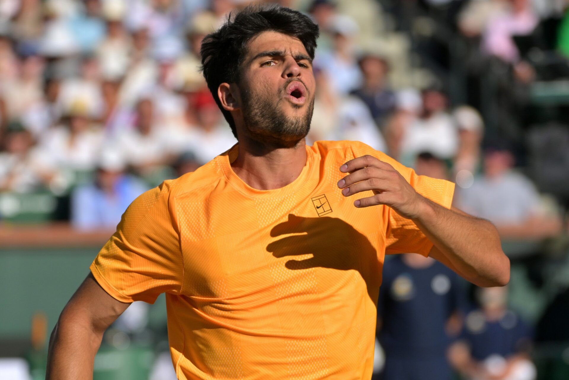 Carlos Alcaraz (ESP) reacts as a ball gets past him at the net during his semifinal match against Daniil Medvedev (RUS) in the BNP Paribas Open at the Indian Wells Tennis Garden.