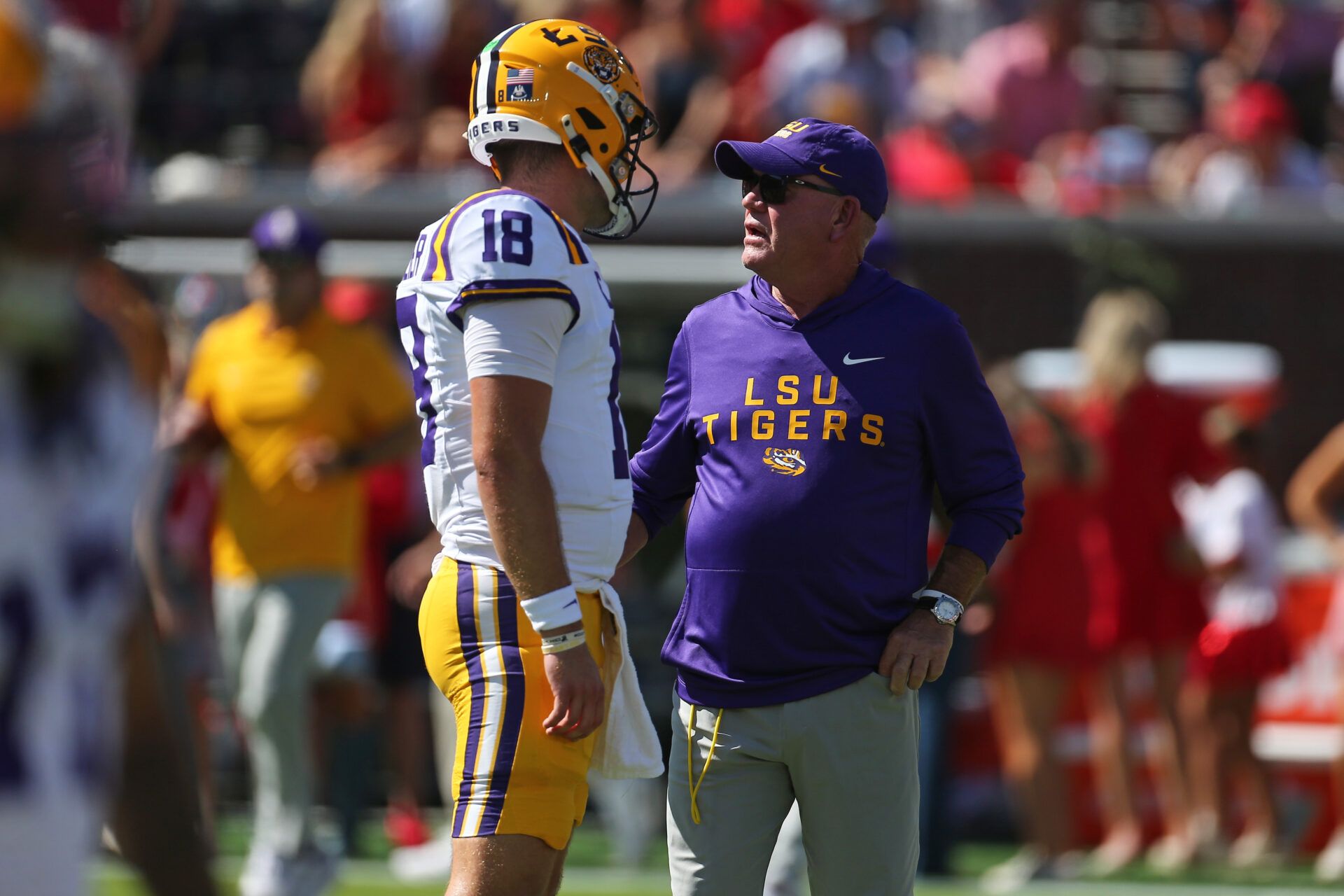 LSU Tigers head coach Brian Kelly talks with quarterback Garrett Nussmeier (18) during warm ups prior to the game against the Mississippi Rebels at Vaught-Hemingway Stadium.