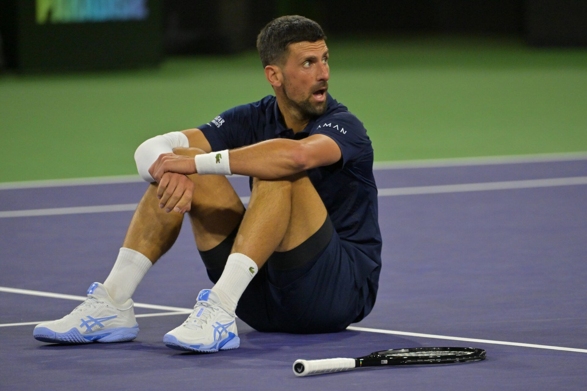 Novak Djokovic (SRB) takes a moment on the court after a long rally during his fourth round match against Jack Draper (GBR) in the BNP Paribas Open at the Indian Wells Tennis Garden.