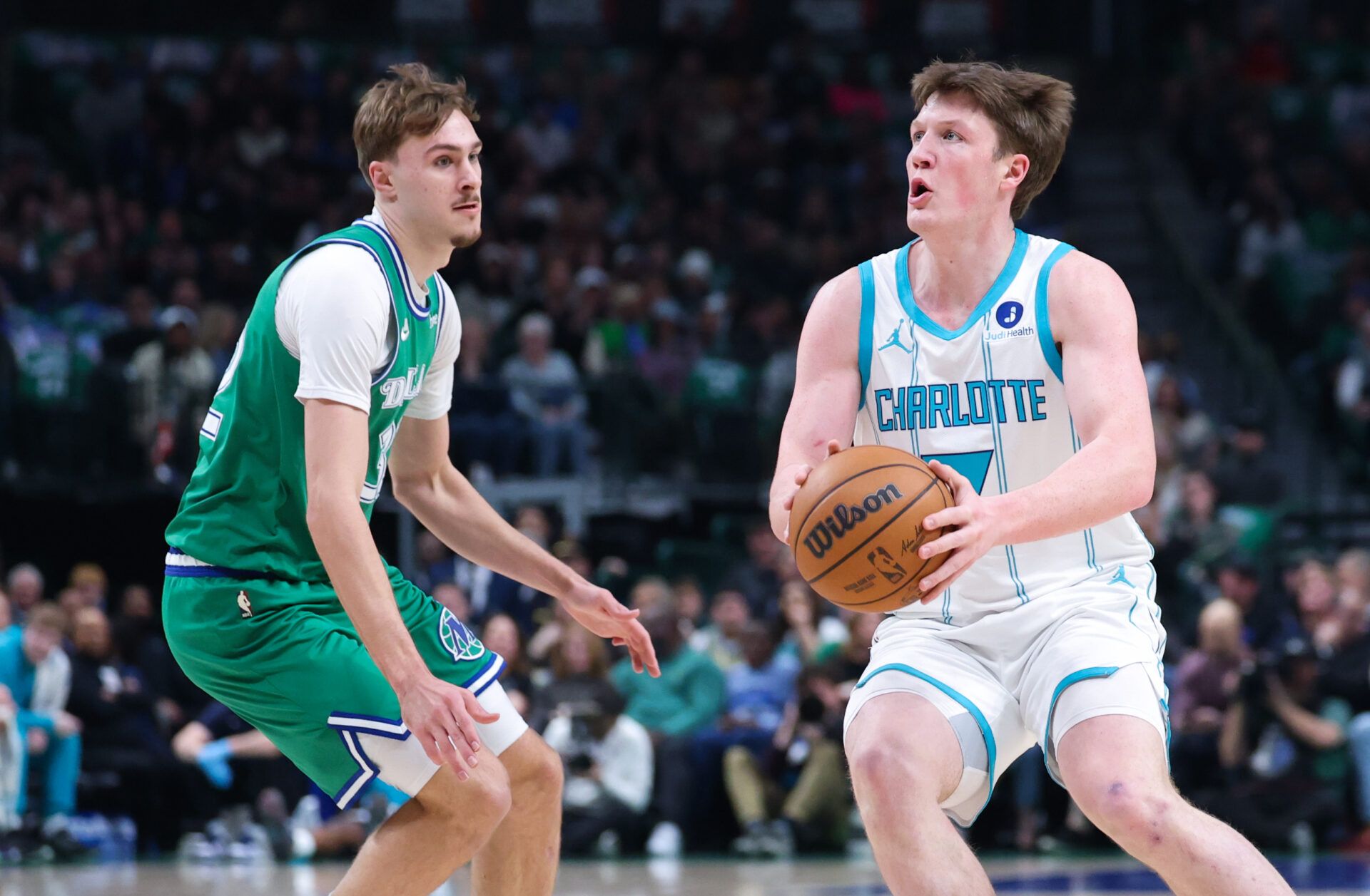 Charlotte Hornets guard Kon Knueppel (7) shoots as Dallas Mavericks forward Cooper Flagg (32) defends during the first quarter at American Airlines Center.
