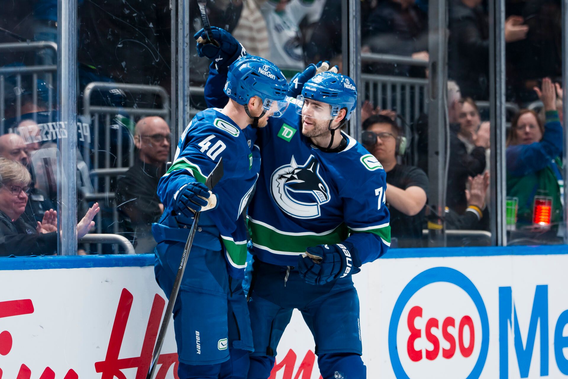 Vancouver Canucks forward Elias Pettersson (40) and forward Jake DeBrusk (74) celebrate DeBrusk’s game winning overtime goal at Rogers Arena.
