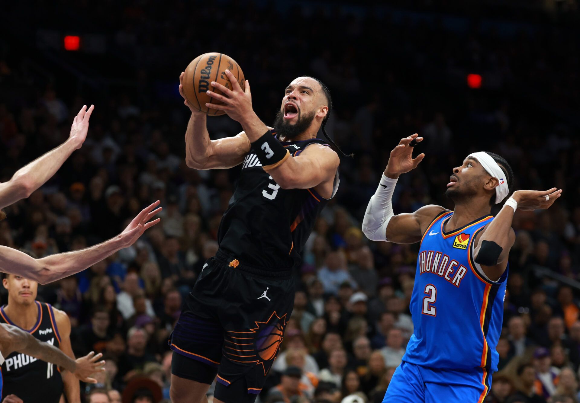 Phoenix Suns forward Dillon Brooks (3) drives to the basket against Oklahoma City Thunder guard Shai Gilgeous-Alexander (2) at Mortgage Matchup Center.