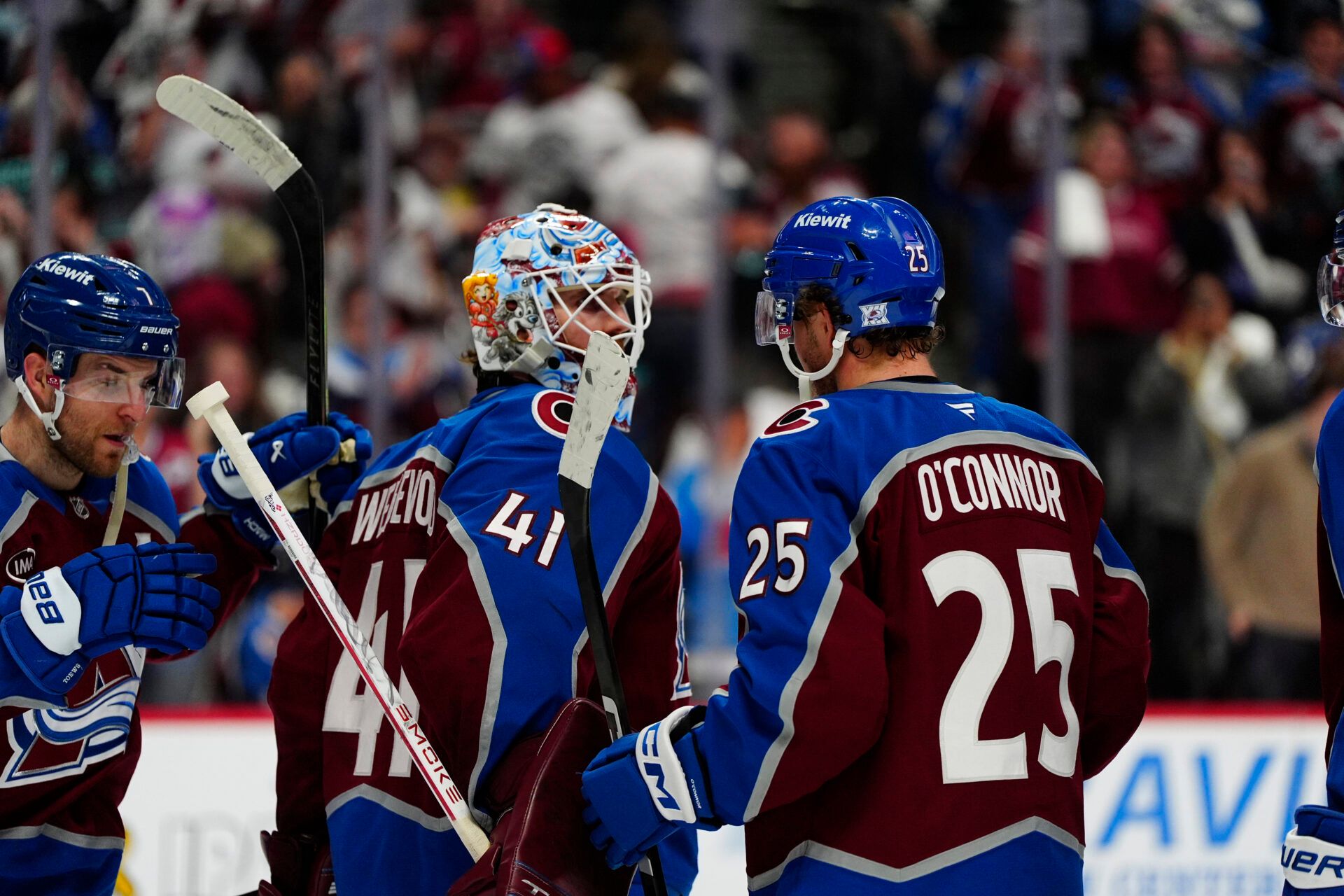 Colorado Avalanche goaltender Scott Wedgewood (41) and right wing Logan O'Connor (25) celebrate the win at Ball Arena.