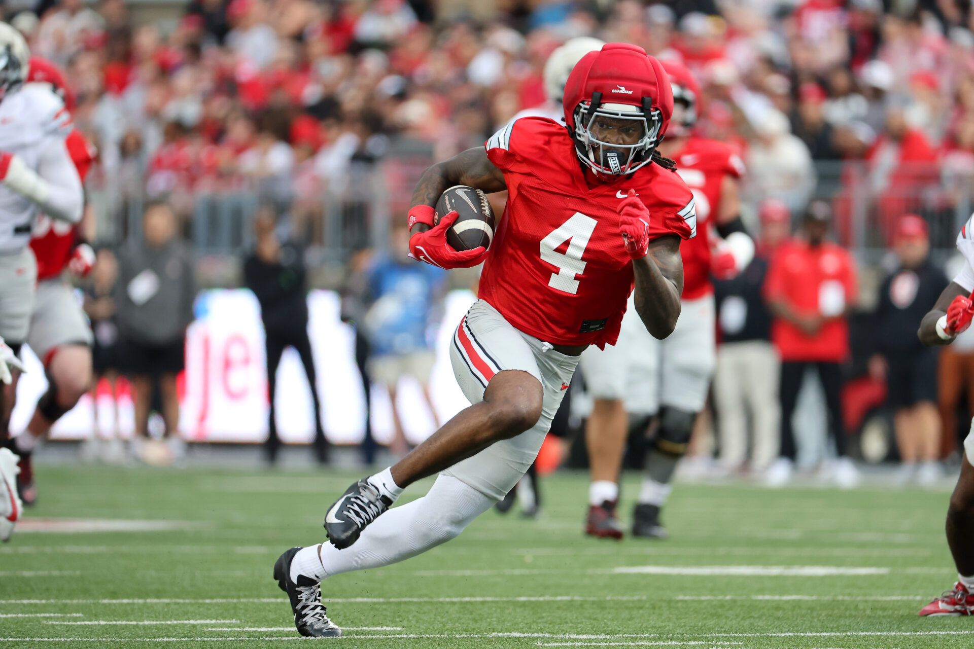 Ohio State Wide receiver Jeremiah Smith (4) runs after catching the ball during the annual spring game at Ohio Stadium.