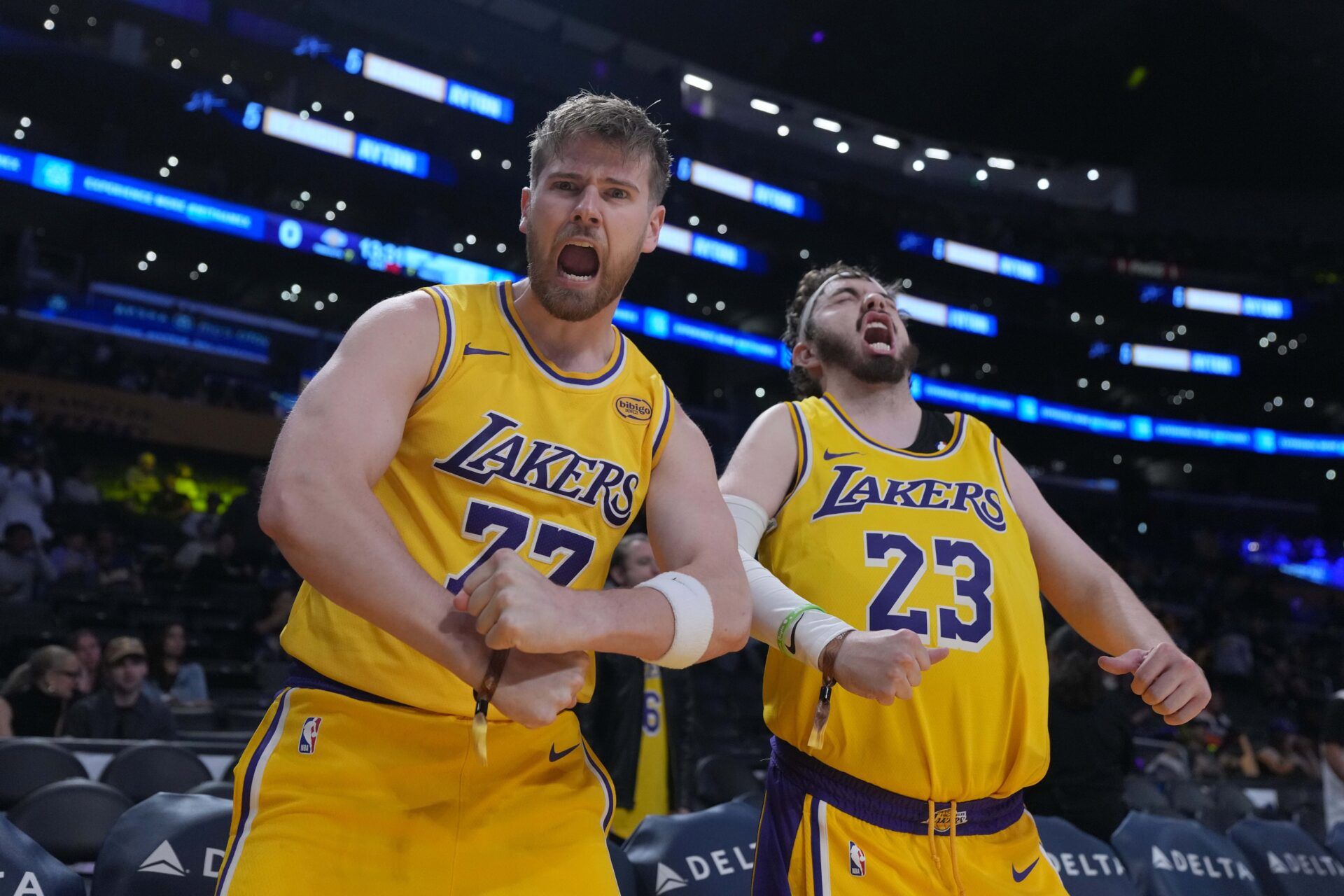 Los Angeles Lakers fans Tom Biddle (left) and Mantis Taylor dressed in the uniforms of Lakers guard Luka Doncic (77) and forward LeBron James (23) pose in the first half against the Utah Jaz at the Crypto.com Arena.