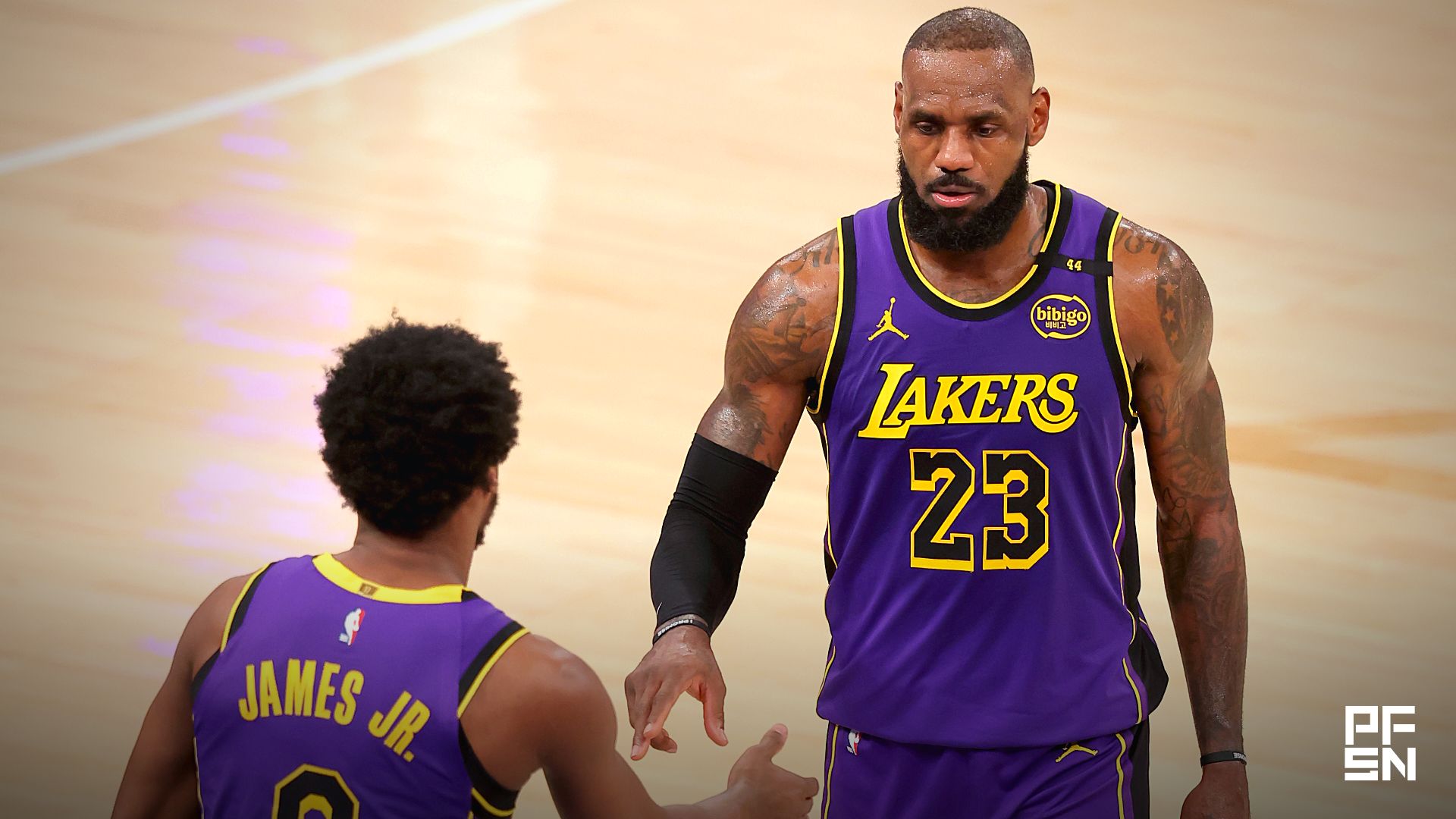 Los Angeles Lakers guard Bronny James (9) checks in for forward LeBron James (23) during the fourth quarter against the New York Knicks at Madison Square Garden.