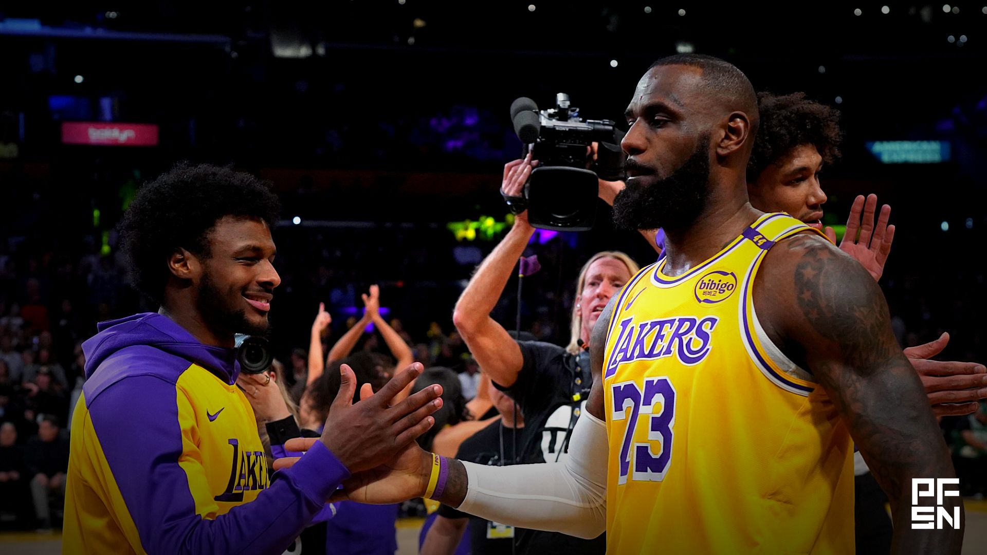 Los Angeles Lakers forward LeBron James (23) interacts with son Bronny James during the game against the Boston Celtics at the Crypto.com Arena.