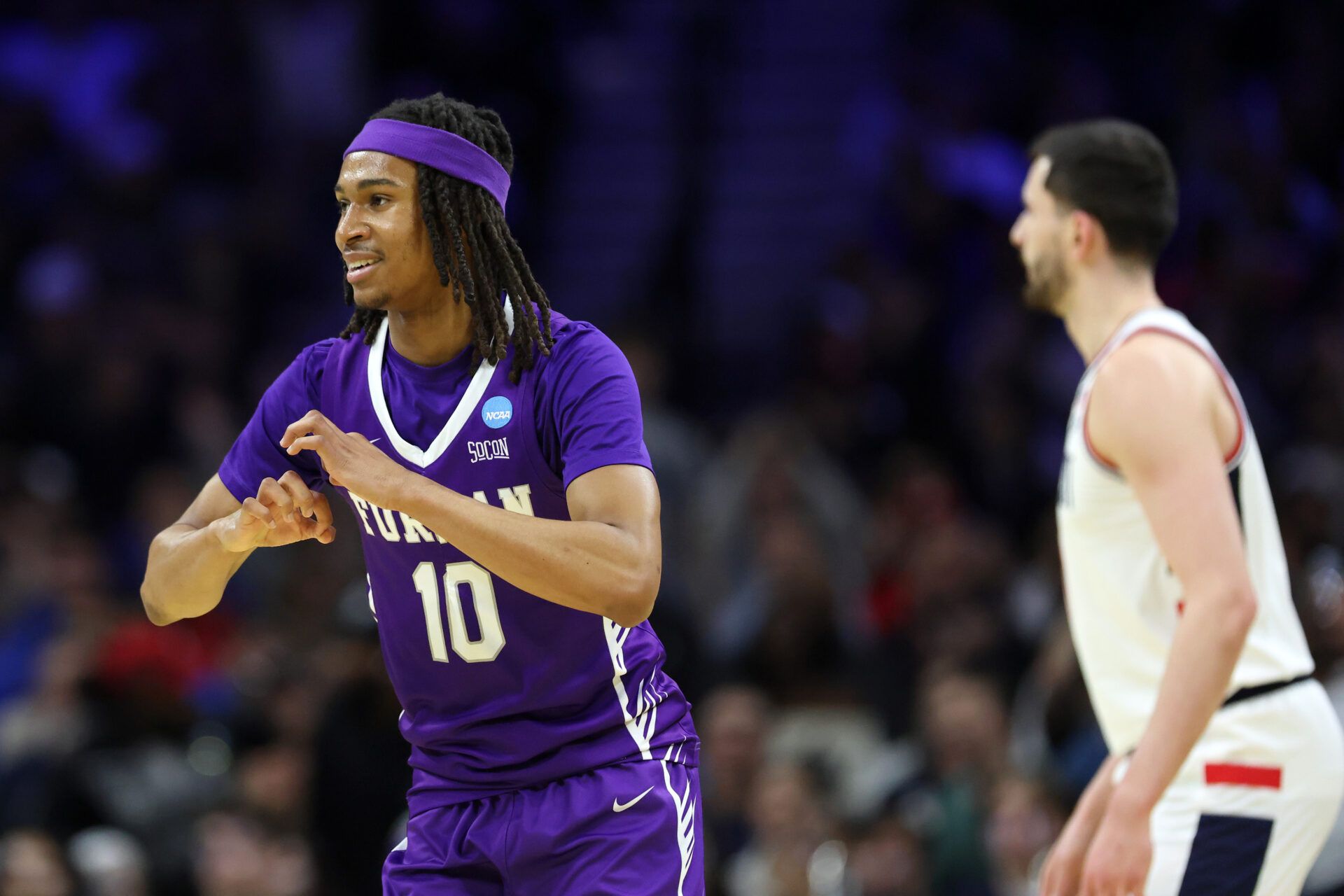 Furman Paladins guard Alex Wilkins (10) reacts against the UConn Huskies in the first half during a first round game of the men's 2026 NCAA Tournament at Xfinity Mobile Arena.