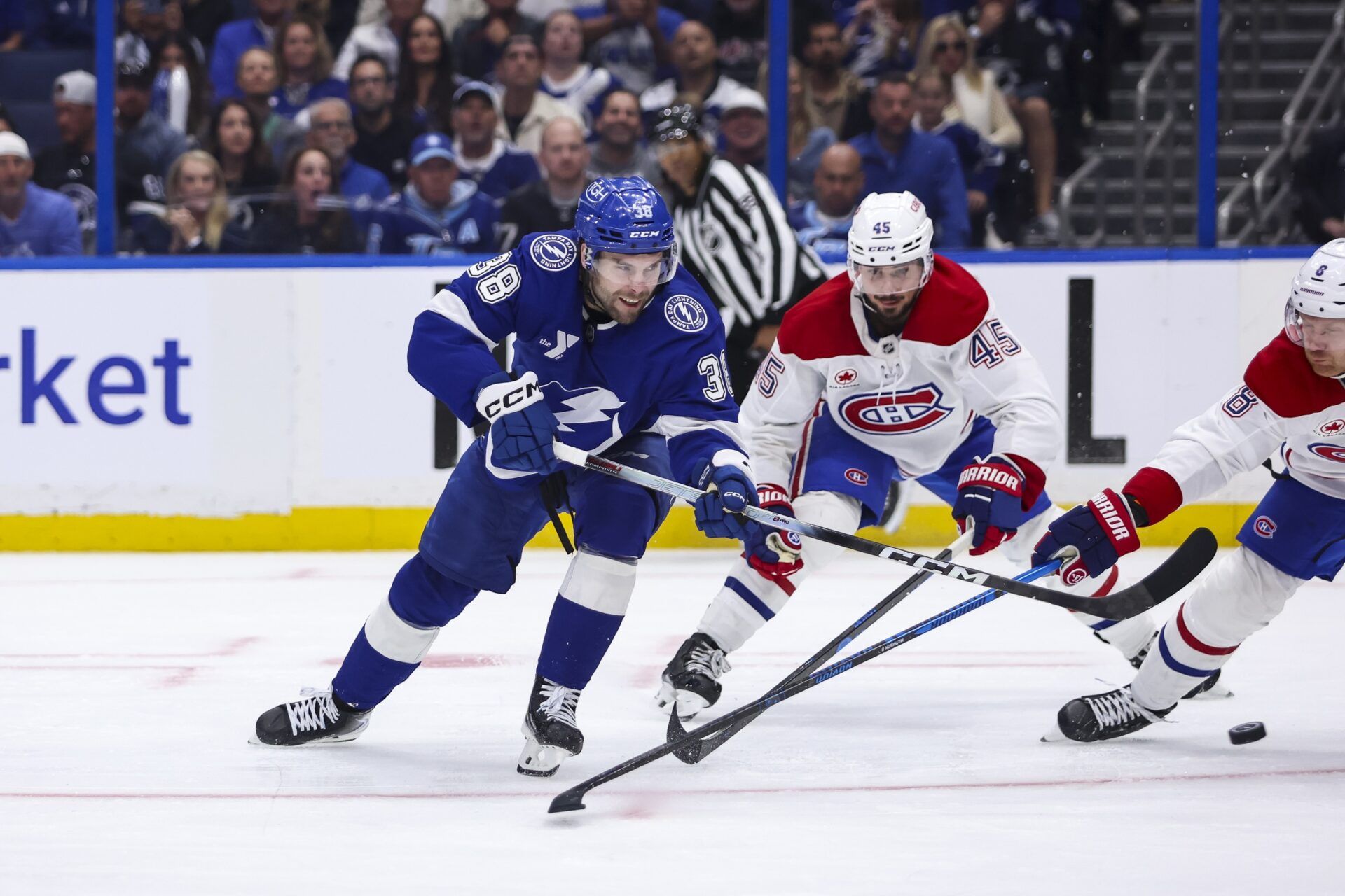 Tampa Bay Lightning forward Brandon Hagel (38) takes a shot under pressure from Montreal Canadiens defenseman Lane Hutson (48) and defenseman Mike Matheson (8) during the third period in game one of the first round of the 2026 Stanley Cup Playoffs at Benchmark International Arena.
