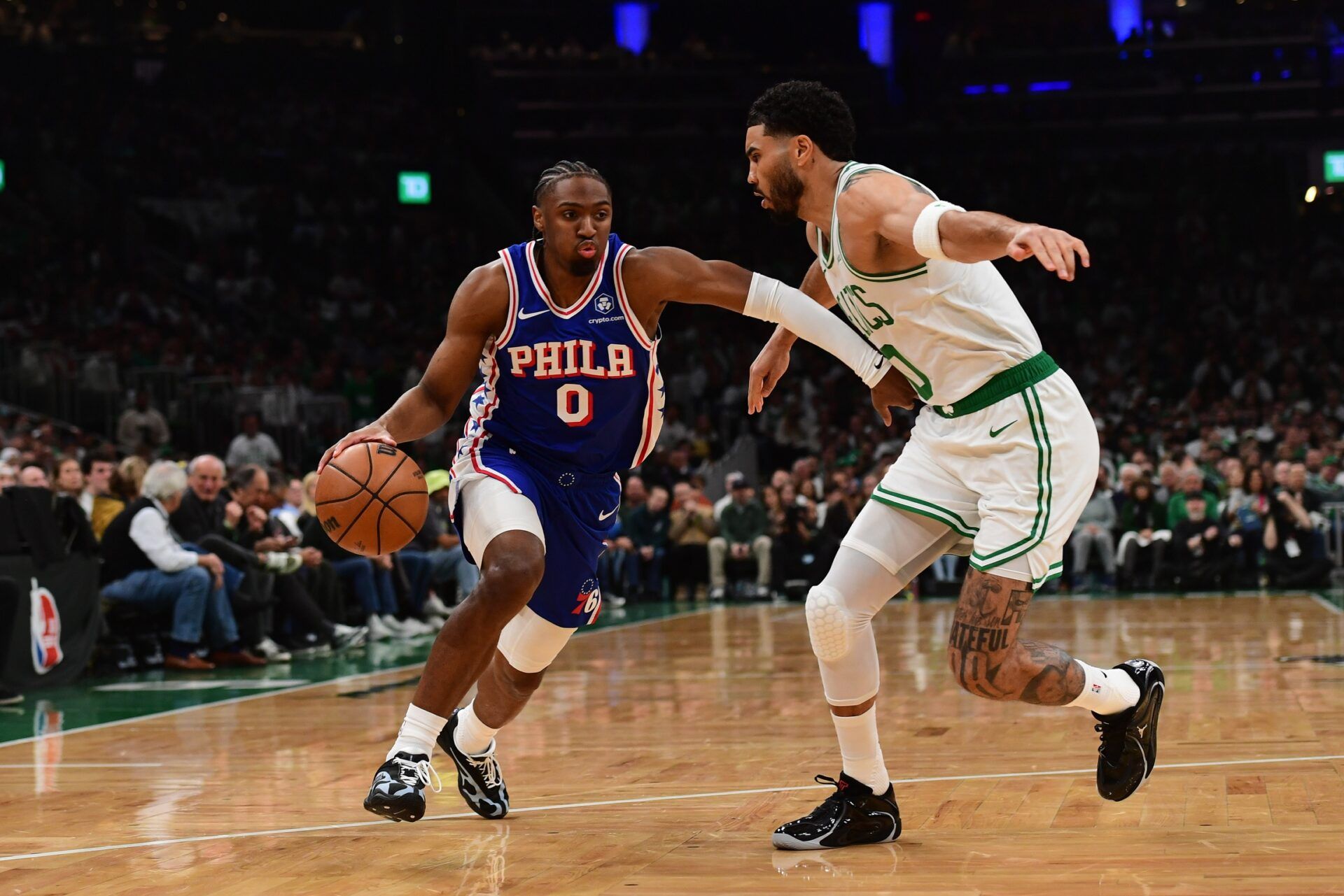 Philadelphia 76ers guard Tyrese Maxey (0) controls the ball while Boston Celtics forward Jayson Tatum (0) defends in the first half during game one of the first round of the 2026 NBA Playoffs at TD Garden.