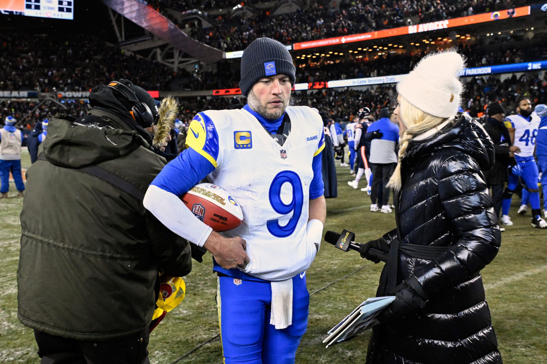 Los Angeles Rams quarterback Matthew Stafford (9) holds a game ball as he is interviewed by NBC sideline reporter Melissa Stark after a NFC Divisional Round game against the Chicago Bears at Soldier Field.