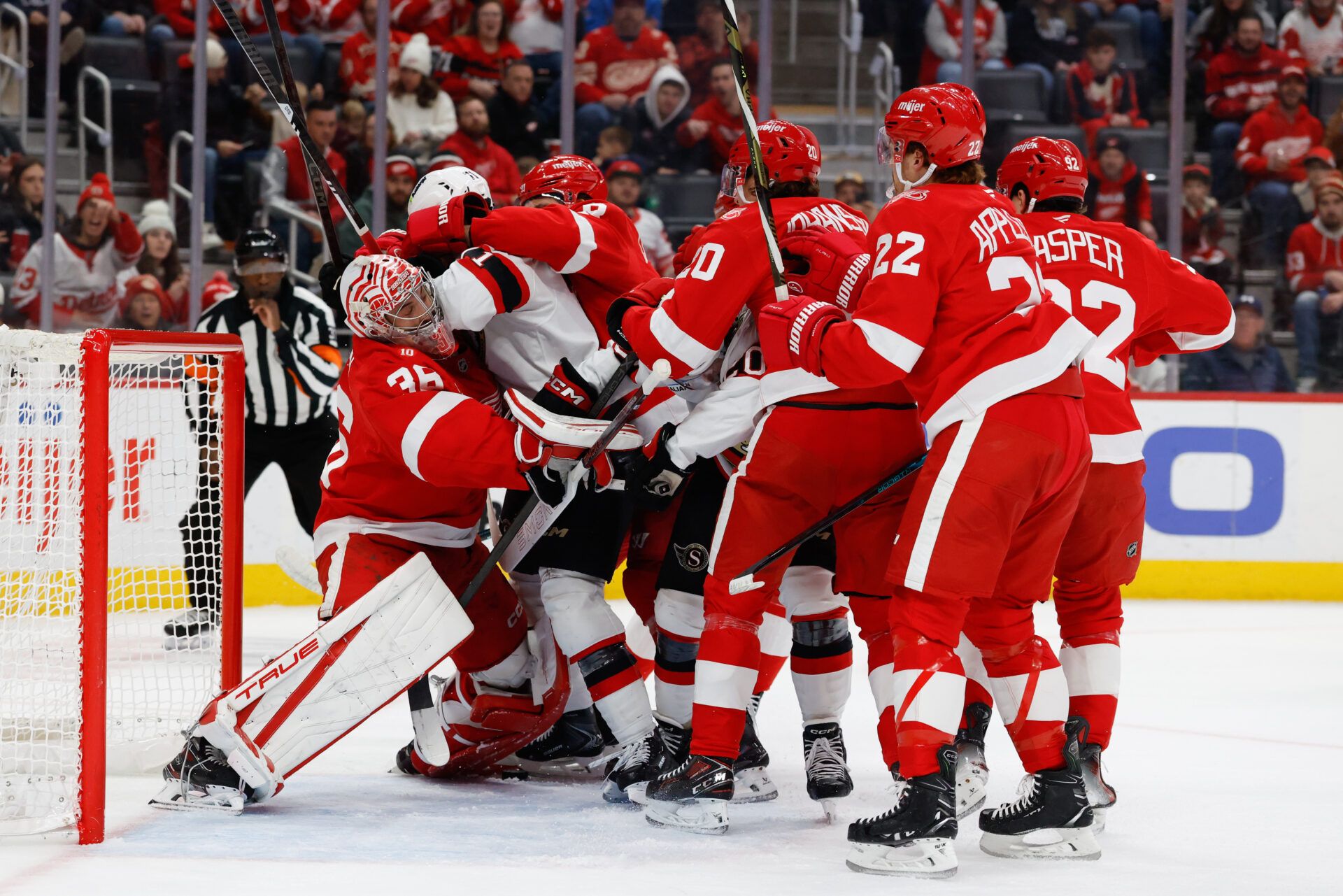 Players pile up on Detroit Red Wings goaltender John Gibson (36) at Little Caesars Arena.