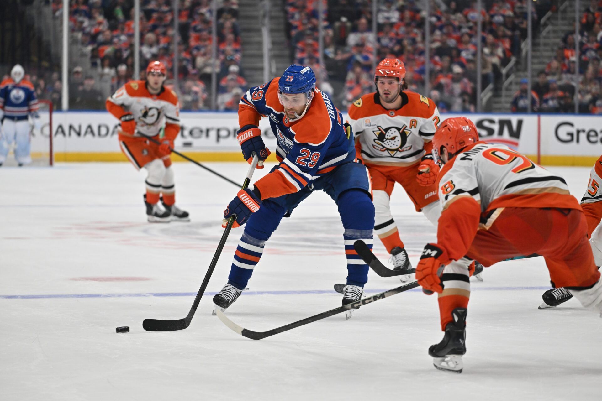 Edmonton Oilers center Leon Draisaitl (29) and Anaheim Ducks defenseman Pavel Mintyukov (98) battle for the puck in game one of the first round of the 2026 Stanley Cup Playoffs during the third period at Rogers Place.