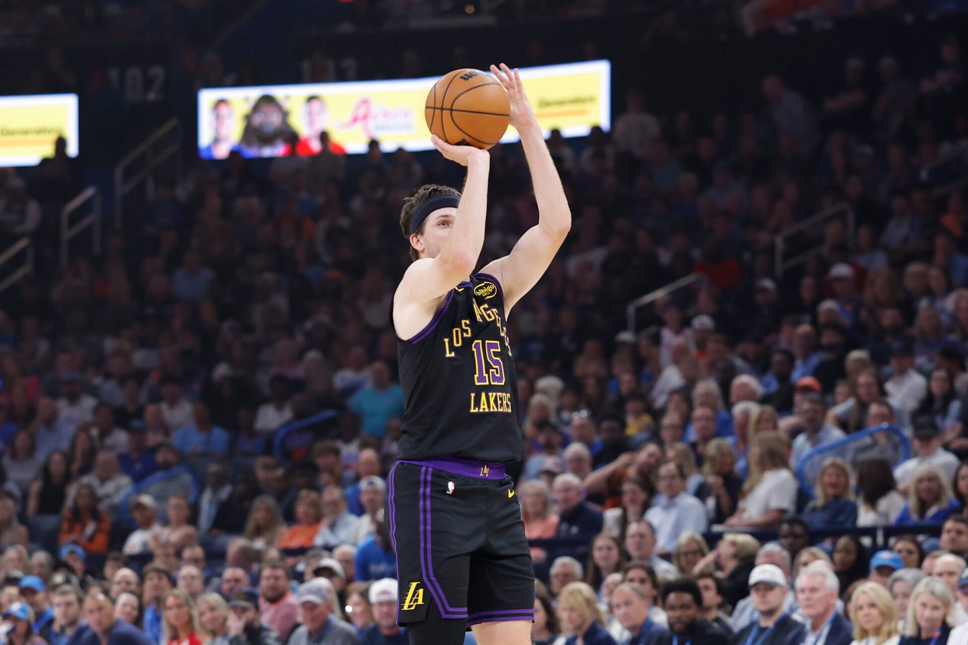 Los Angeles Lakers guard Austin Reaves (15) shoots a three point basket against the Oklahoma City Thunder during the first quarter at Paycom Center.