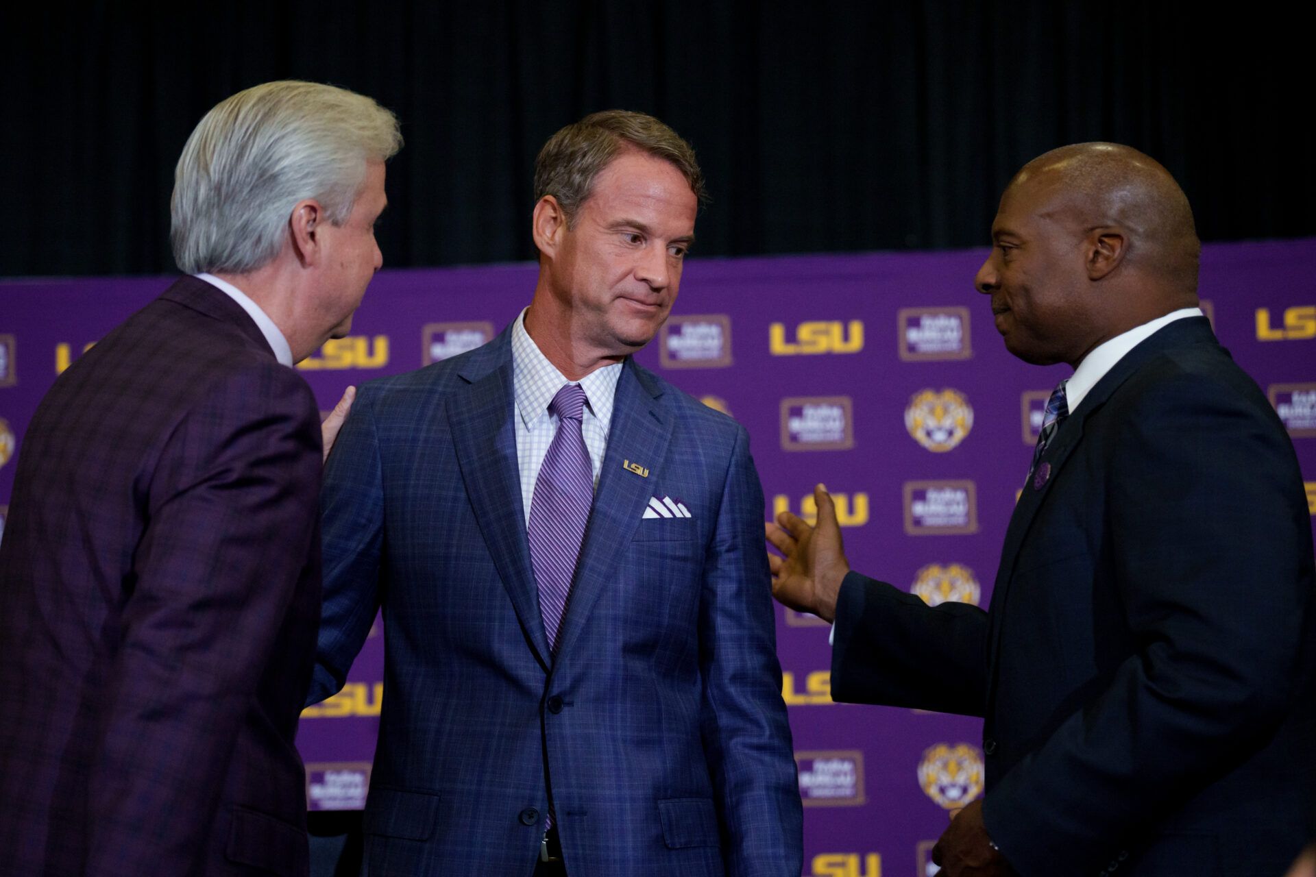 LSU president Wade Rousse, left, LSU new head coach Lane Kiffin, and LSU athletic director Verge Ausberry greet each other at South Stadium Club at Tiger Stadium.