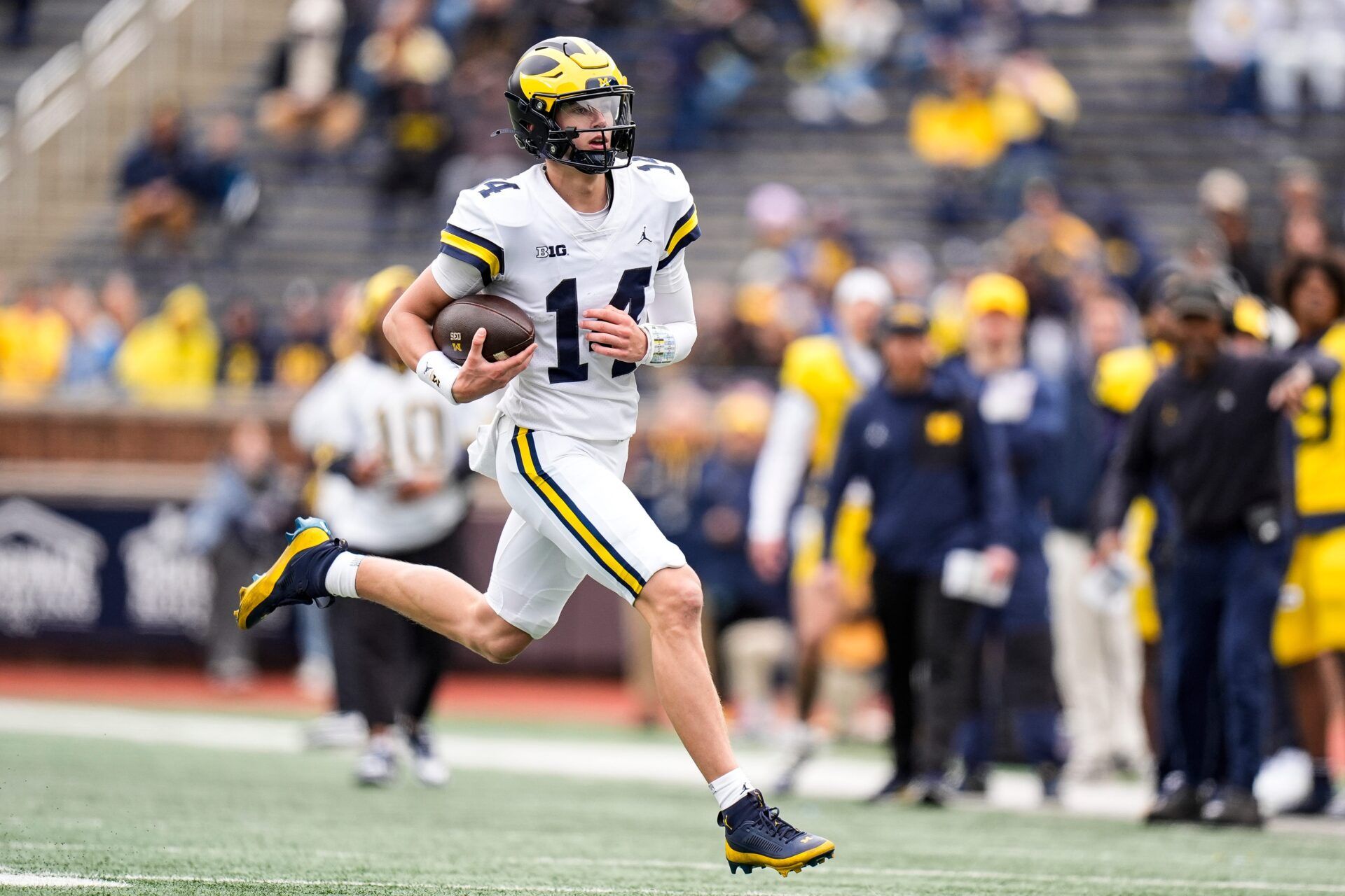 Michigan quarterback Tommy Carr (14) runs the ball during the spring game at Michigan Stadium in Ann Arbor on Saturday, April 18, 2026.