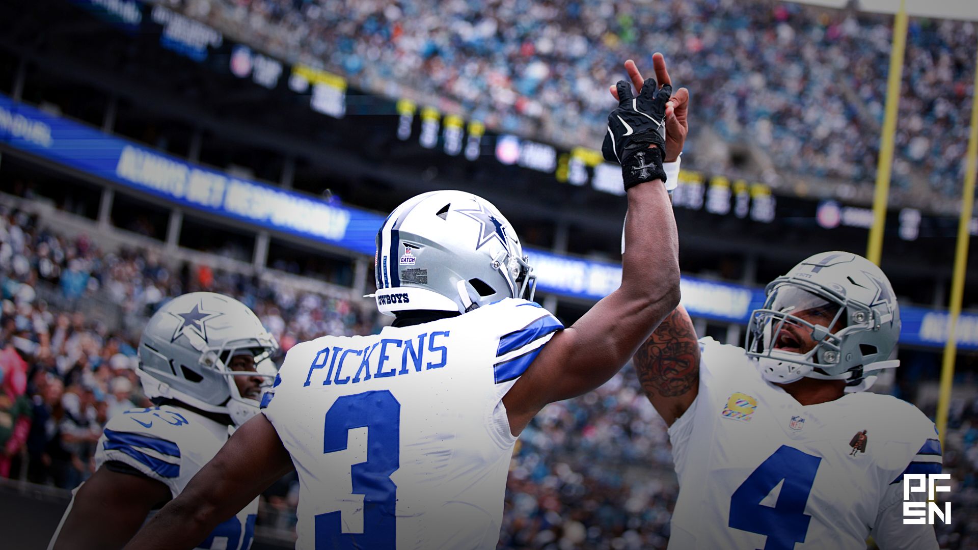 Dallas Cowboys wide receiver George Pickens (3) celebrates with quarterback Dak Prescott (4) during the first half at Bank of America Stadium.