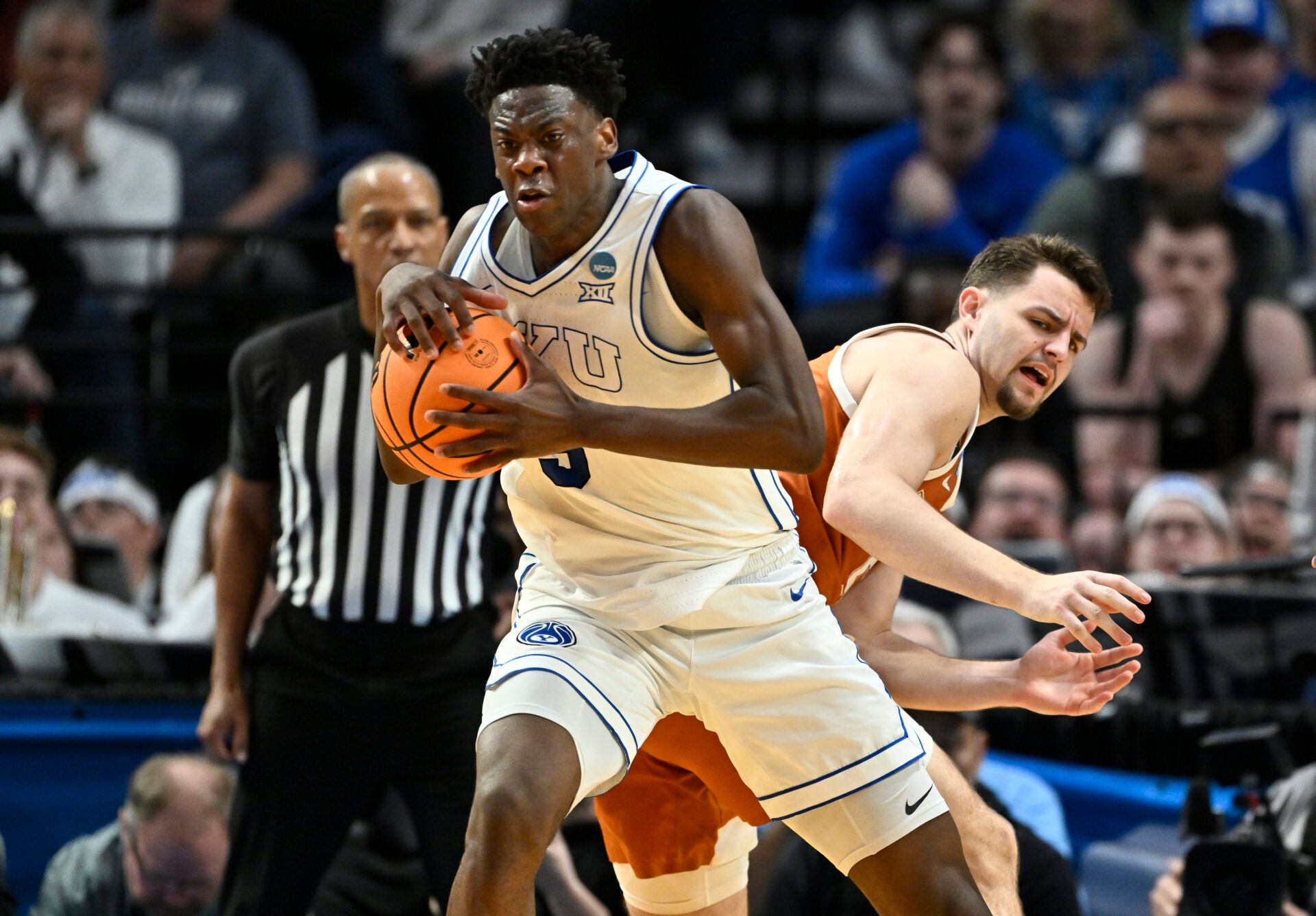 BYU Cougars forward AJ Dybantsa (3) keeps the ball from Texas Longhorns forward Camden Heide (5) in the second half during a first round game of the men's 2026 NCAA Tournament at Moda Center.