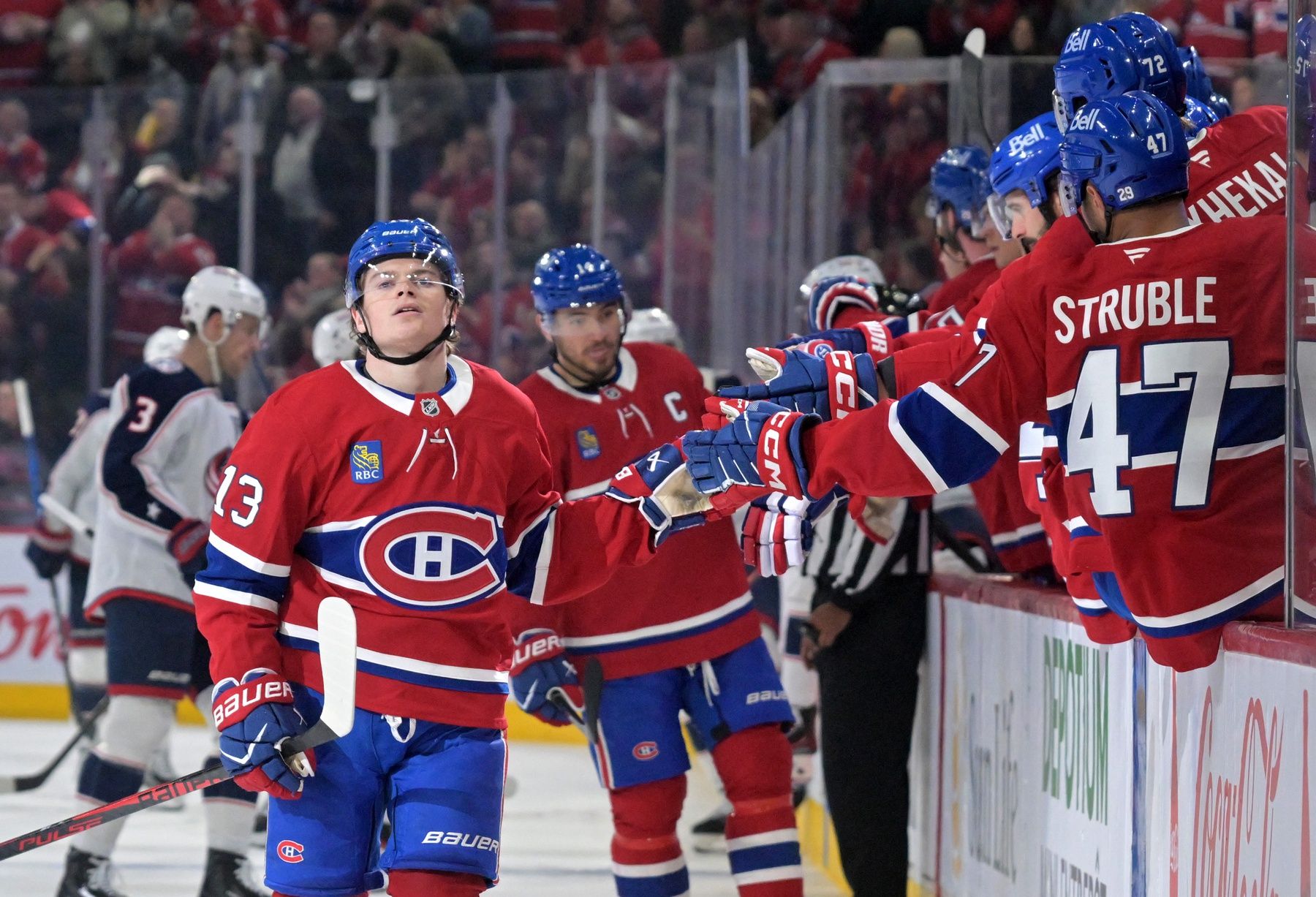 Montreal Canadiens forward Cole Caufield (13) celebrates with teammates after scoring a goal against the Columbus Blue Jackets during the third period at the Bell Centre.