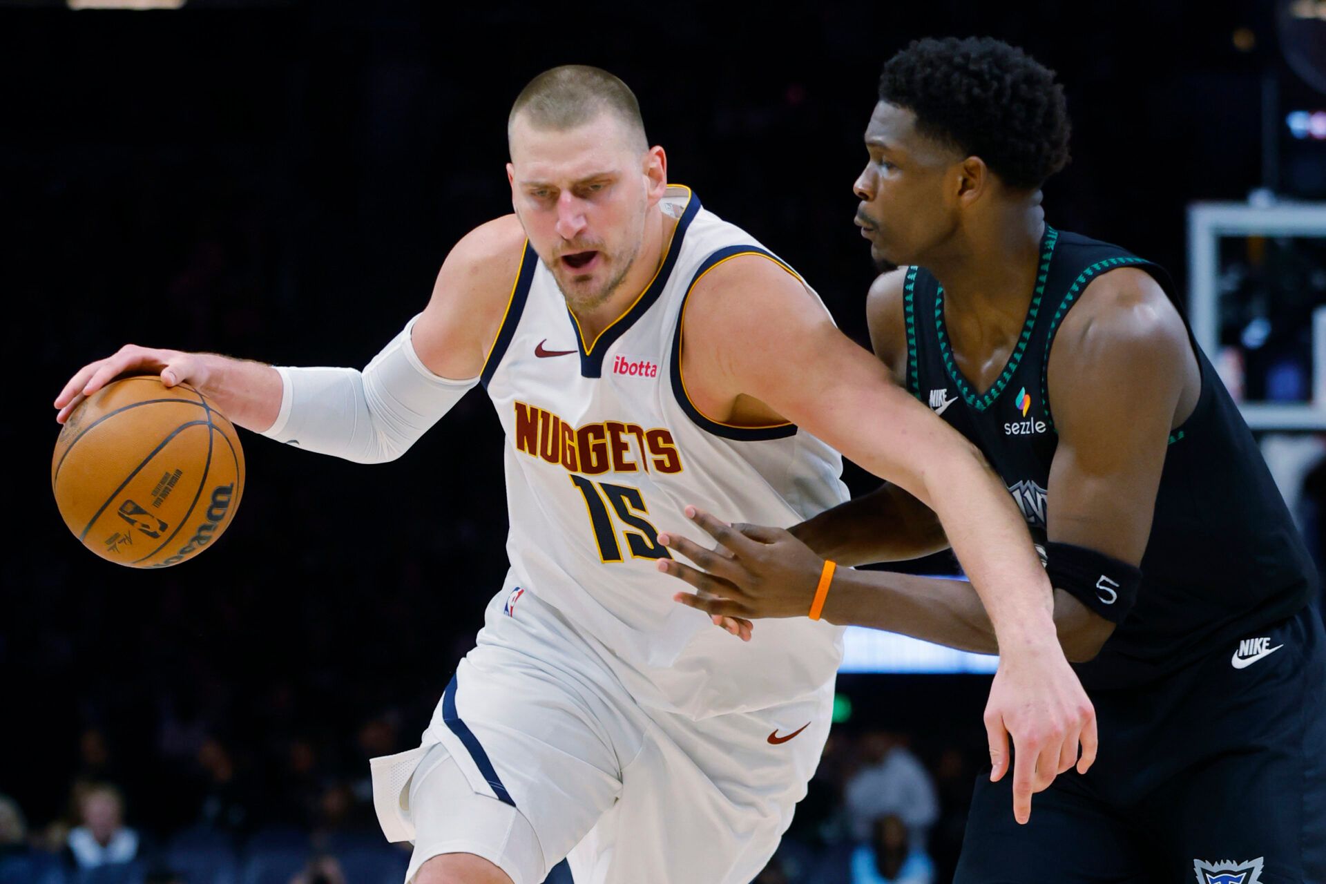Denver Nuggets center Nikola Jokic (15) works around Minnesota Timberwolves guard Anthony Edwards (5) in the third quarter at Target Center.
