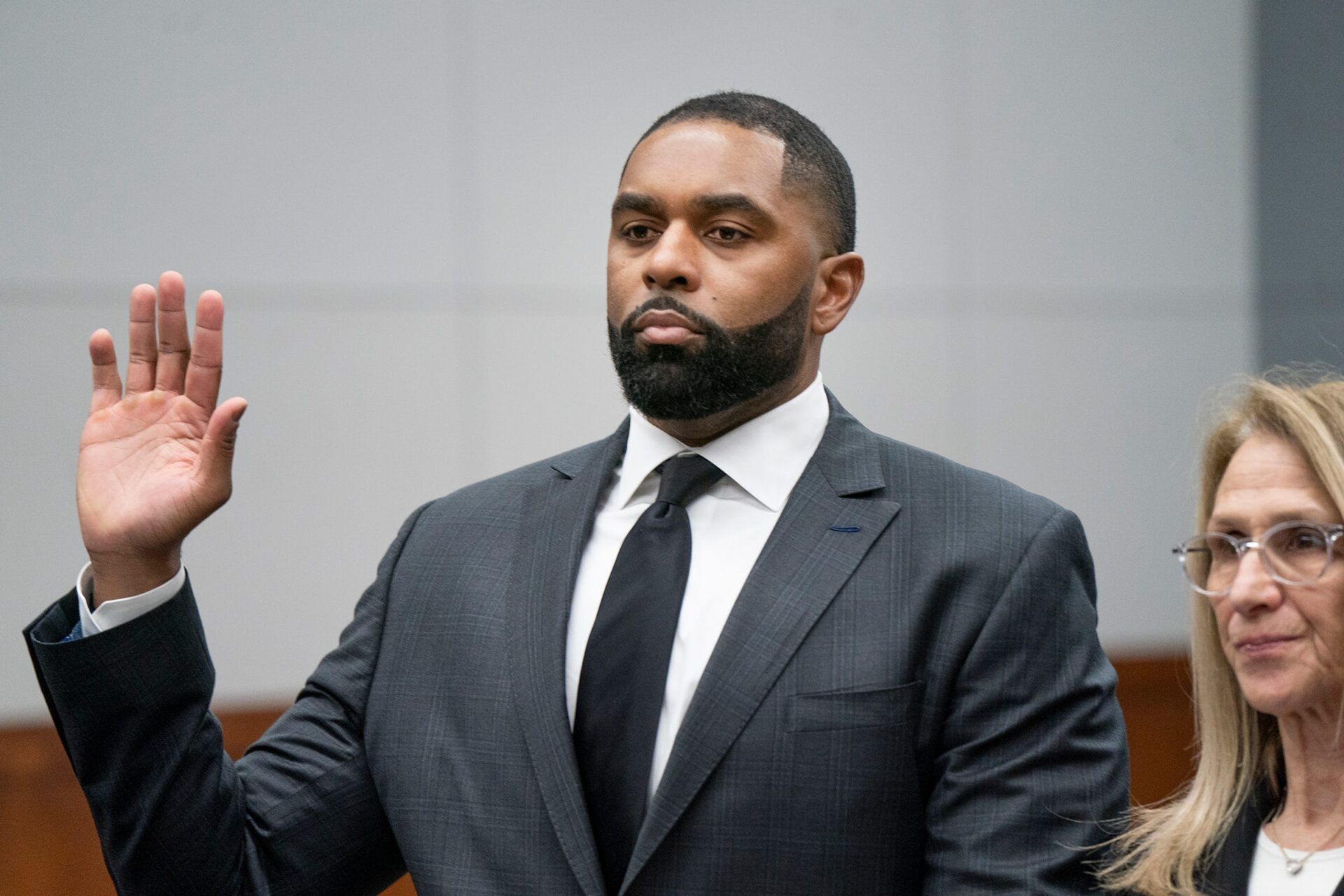Former University of Michigan head football coach Sherrone Moore, left, is sworn in with his attorney Ellen Michaelsat right before he takes a plea in front of Judge J. Cedric Simpson at the 14A-1 District Court in Ann Arbor on Friday, March 6, 2026.