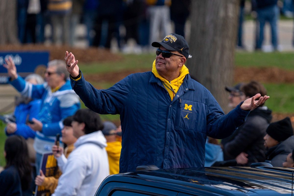 University of Michigan Director of Athletics Warde Manuel interacts with fans from a vehicle during a parade honoring the University of Michigan men’s basketball team’s NCAA national championship in Ann Arbor on Saturday, April 11, 2026.