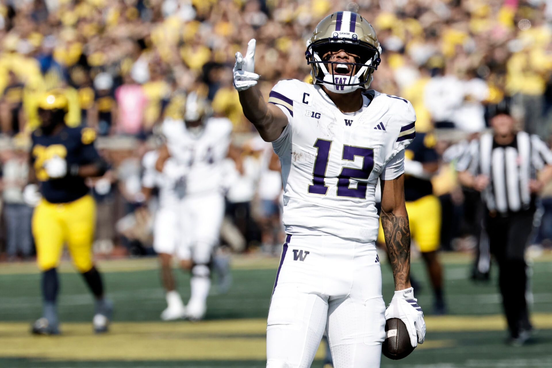 Washington Huskies wide receiver Denzel Boston (12) celebrates after he makes a reception in the first half against the Michigan Wolverines at Michigan Stadium.
