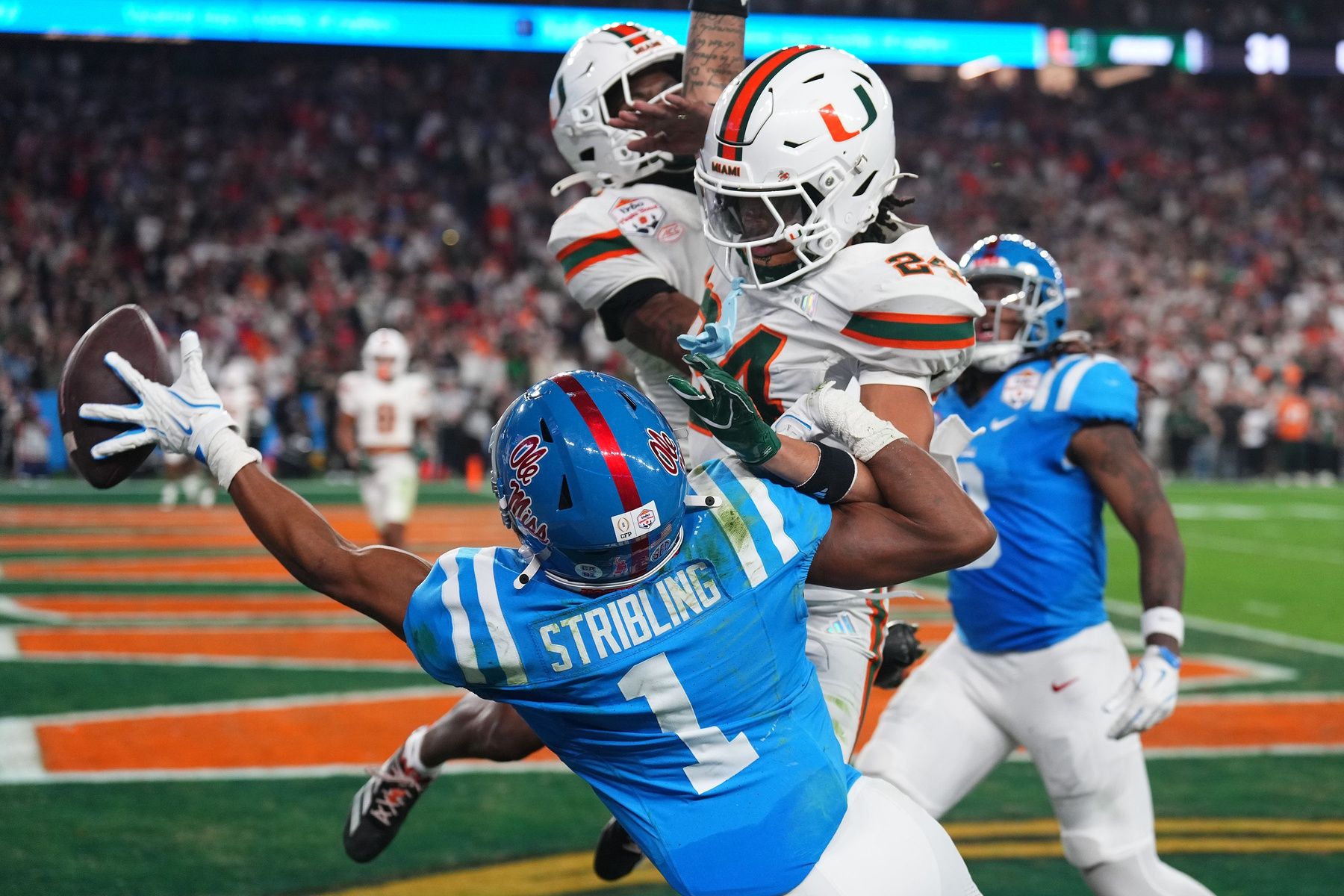 Mississippi Rebels wide receiver De'zhaun Stribling (1) attempts to make a catch against Miami  Hurricanes defensive back Ethan O'Connor (24) in the second half during the 2026 Fiesta Bowl and semifinal game of the College Football Playoff at State Farm Stadium.