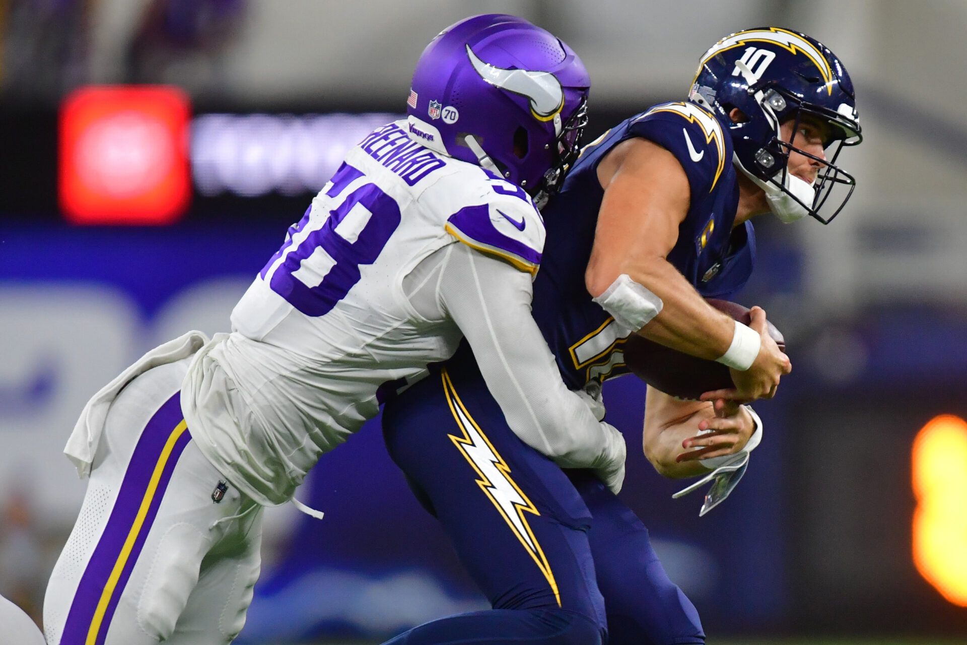 Minnesota Vikings linebacker Jonathan Greenard (58) gets pressure on Los Angeles Chargers quarterback Justin Herbert (10) during the first half at SoFi Stadium.