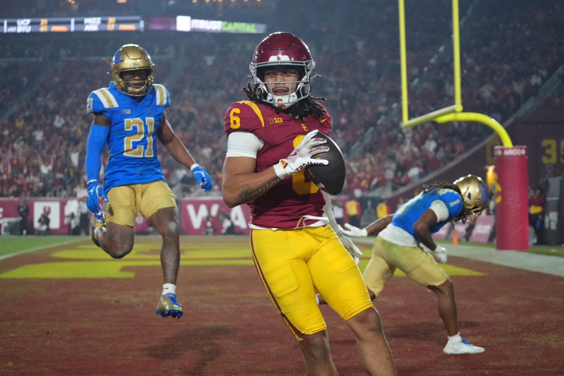 Southern California Trojans wide receiver Makai Lemon (6) catches a 32-yard touchdown pass against UCLA Bruins defensive back Kanye Clark (1) in the second half at United Airlines Field at Los Angeles Memorial Coliseum.