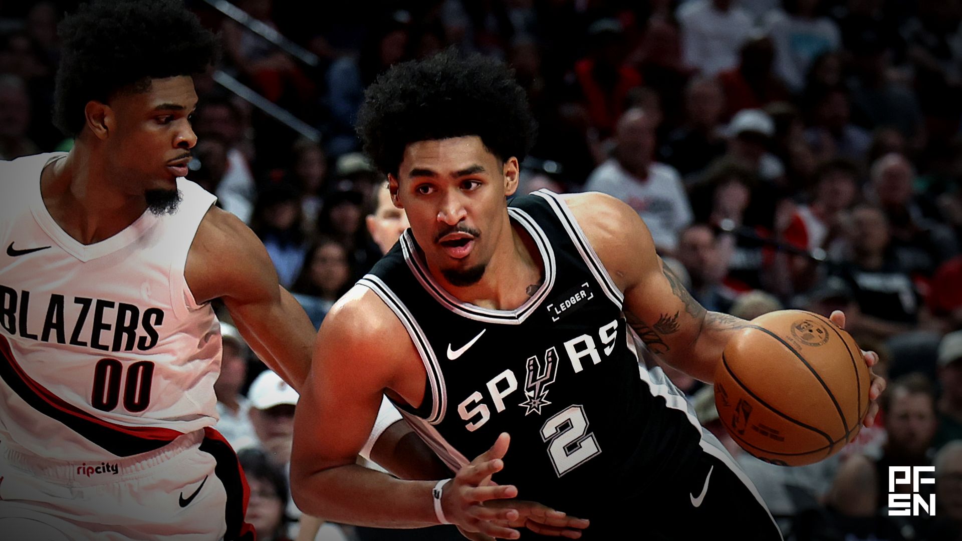 San Antonio Spurs guard Dylan Harper (2) drives to the basket past Portland Trail Blazers guard Scoot Henderson (00) during the second half during game three of the first round of the 2026 NBA Playoffs at Moda Center.
