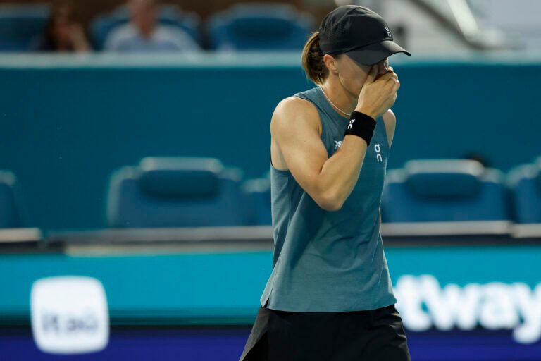 Iga Swiatek (POL) reacts after missing a shot against Magda Linette (POL) (not pictured) on day three of the 2026 Miami Open at Hard Rock Stadium.