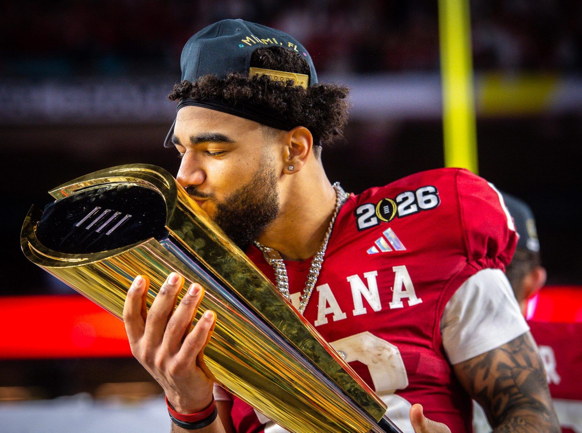 Indiana's Elijah Sarratt (13) kisses the trophy after the College Football Playoff National Championship college football game at Hard Rock Stadium in Miami Gardens on Monday, Jan. 19, 2026.
