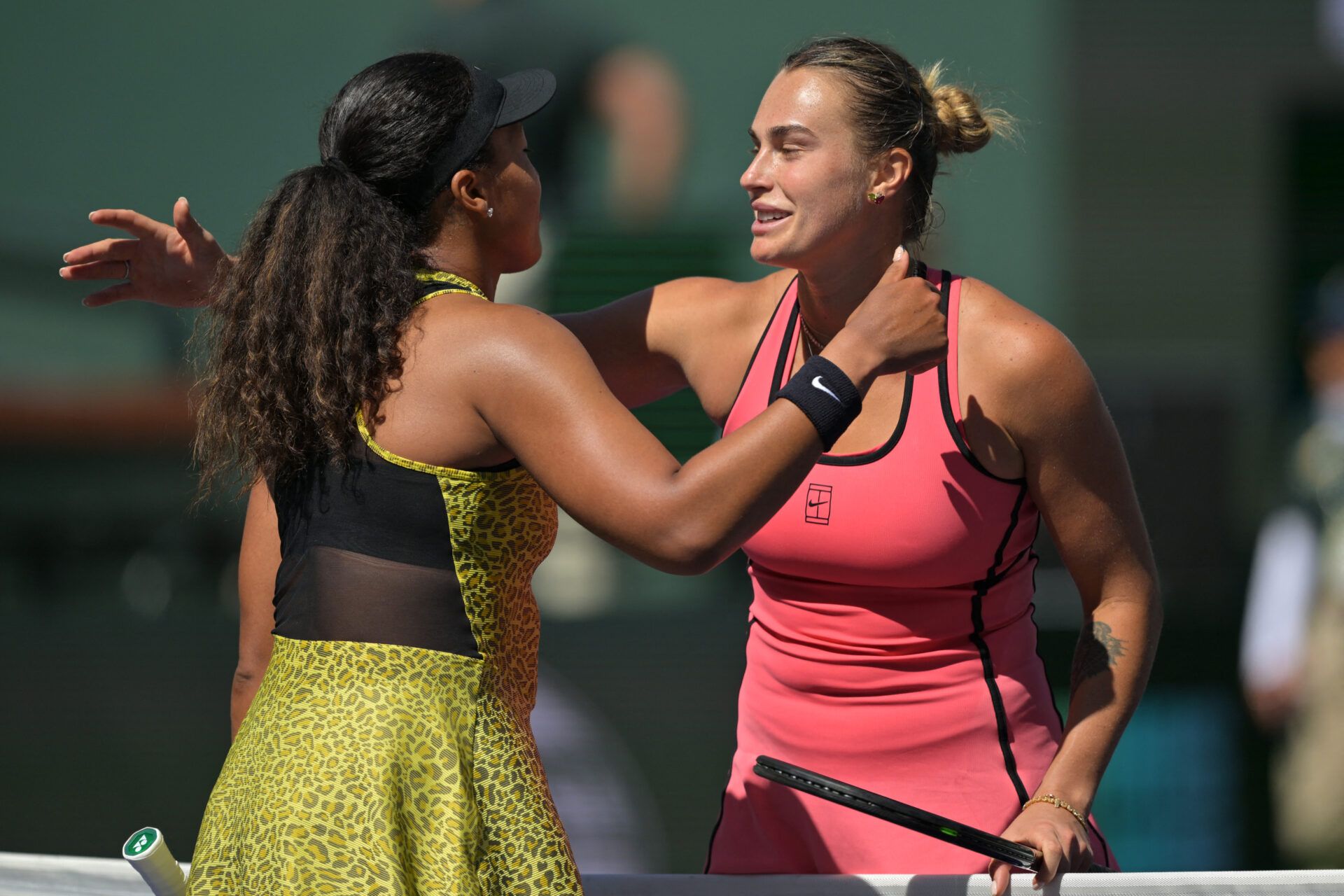 Naomi Osaka (JPN) and Aryna Sabalenka (BEL) embrace after their fourth round match in the BNP Paribas Open at the Indian Wells Tennis Garden.