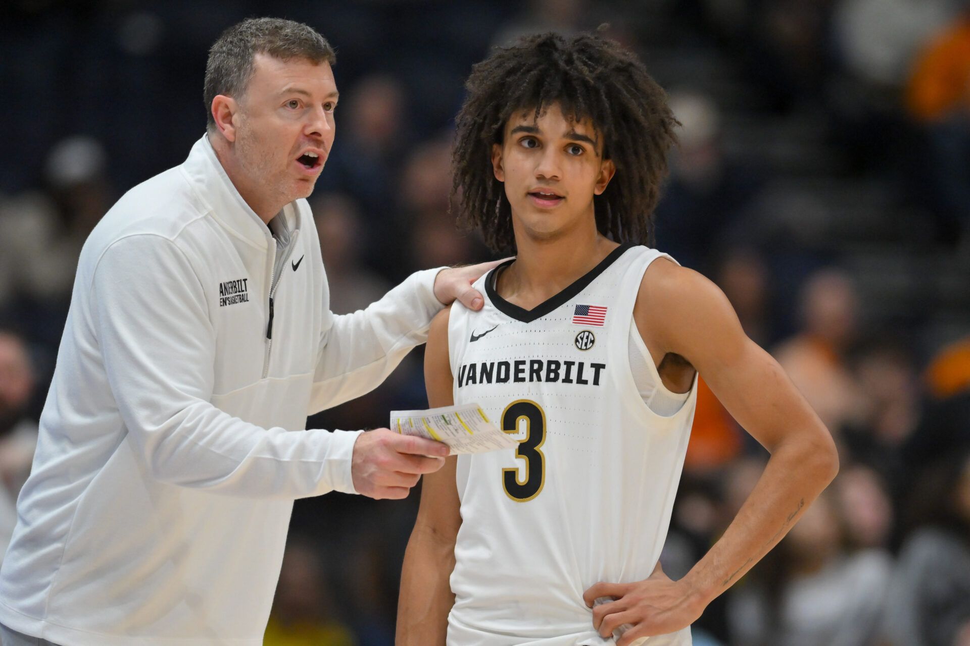 Vanderbilt Commodores head coach Mark Byington talks with guard Tyler Tanner (3) during a break in action against the Tennessee Volunteers  during the second half at Bridgestone Arena.