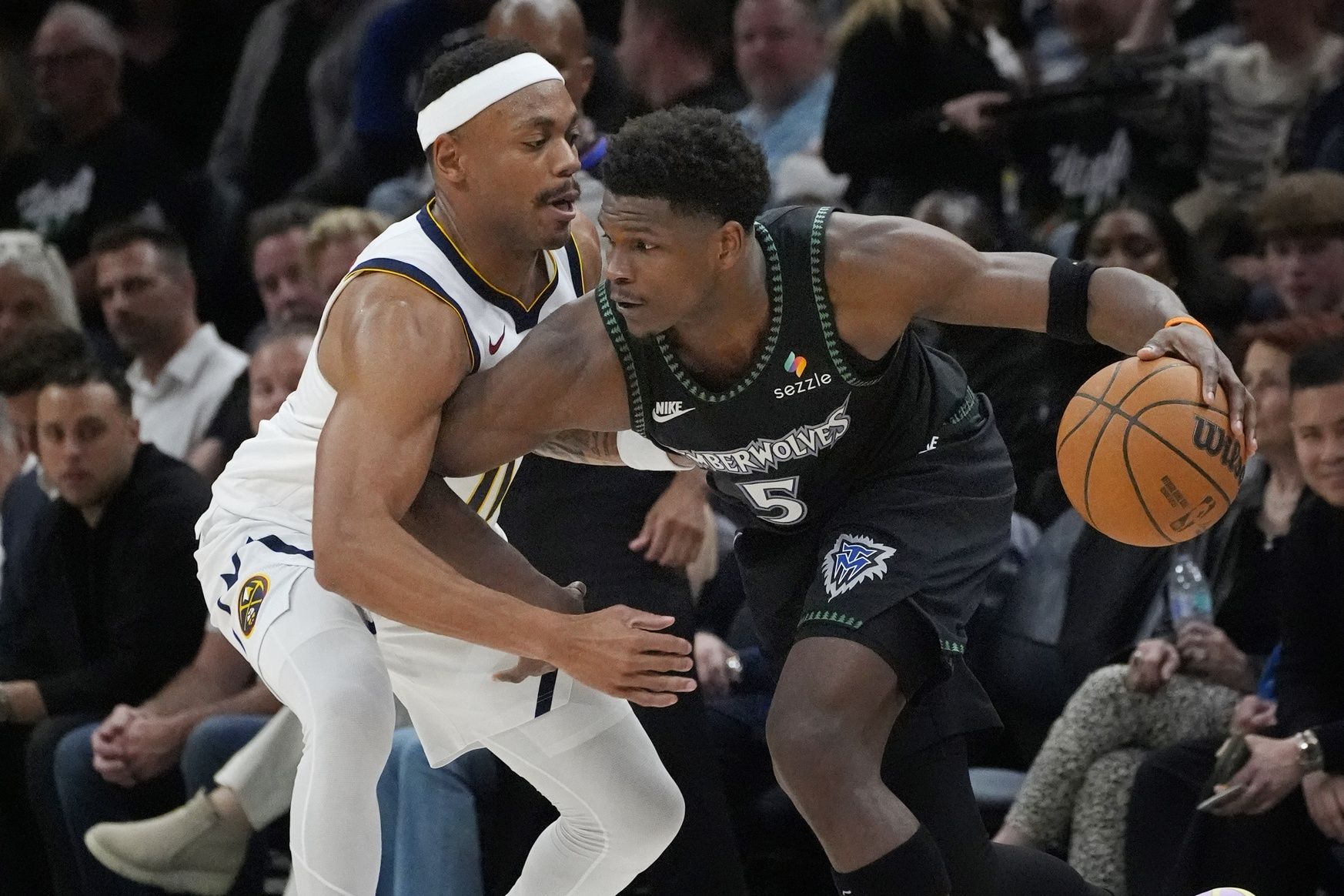 Minnesota Timberwolves guard Anthony Edwards (5) works around Denver Nuggets guard Bruce Brown (11) in the fourth quarter at Target Center.