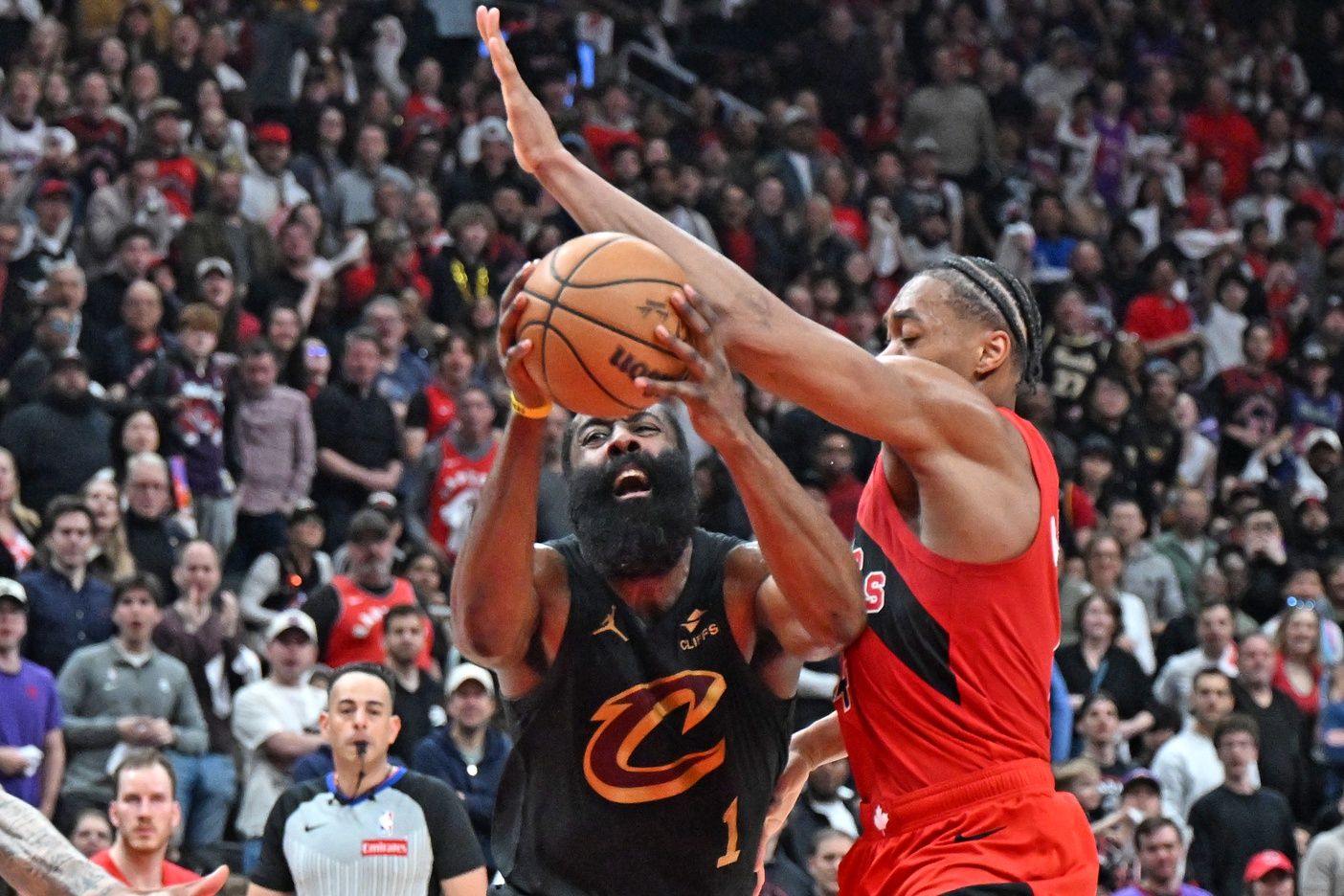 Cleveland Cavaliers guard James Harden (1) battles for the ball with Toronto Raptors forward Scottie Barnes (4) during game four of the first round of the 2026 NBA Playoffs at Scotiabank Arena.