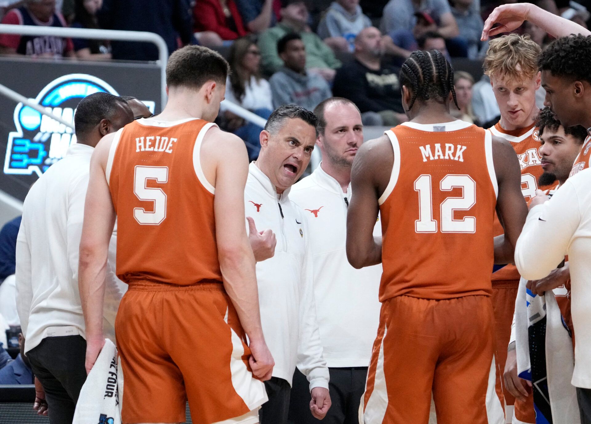 Texas Longhorns head coach Sean Miller talks to Texas Longhorns guard Tramon Mark (12) during a timeout against the Purdue Boilermakers in the second half during a Sweet Sixteen game of the West Regional of the men's 2026 NCAA Tournament at SAP Center.
