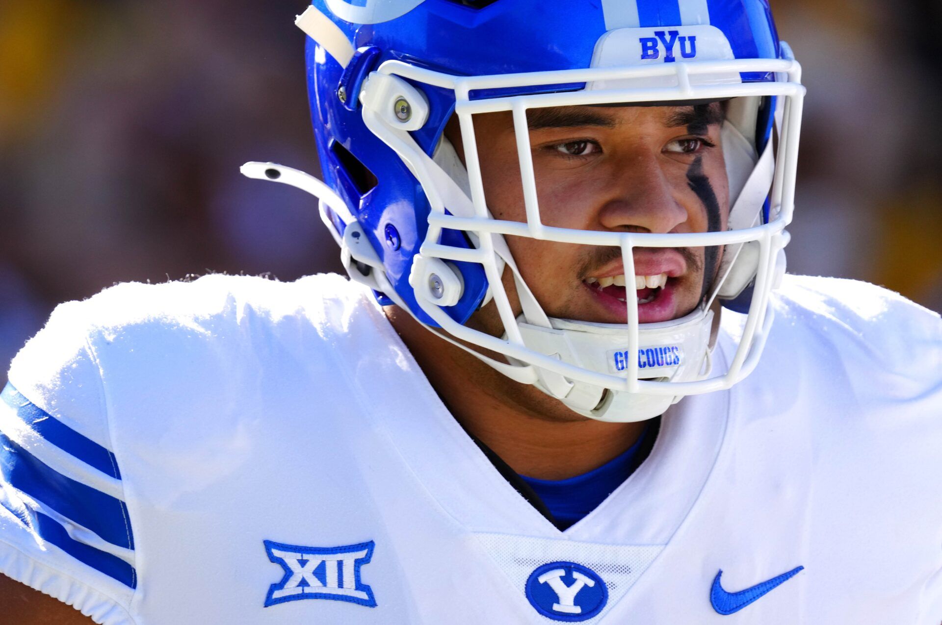 BYU offensive lineman Austin Leausa (55) warms up with teammates prior to the first half at Mountain America Stadium in Tempe on Nov. 23, 2024.