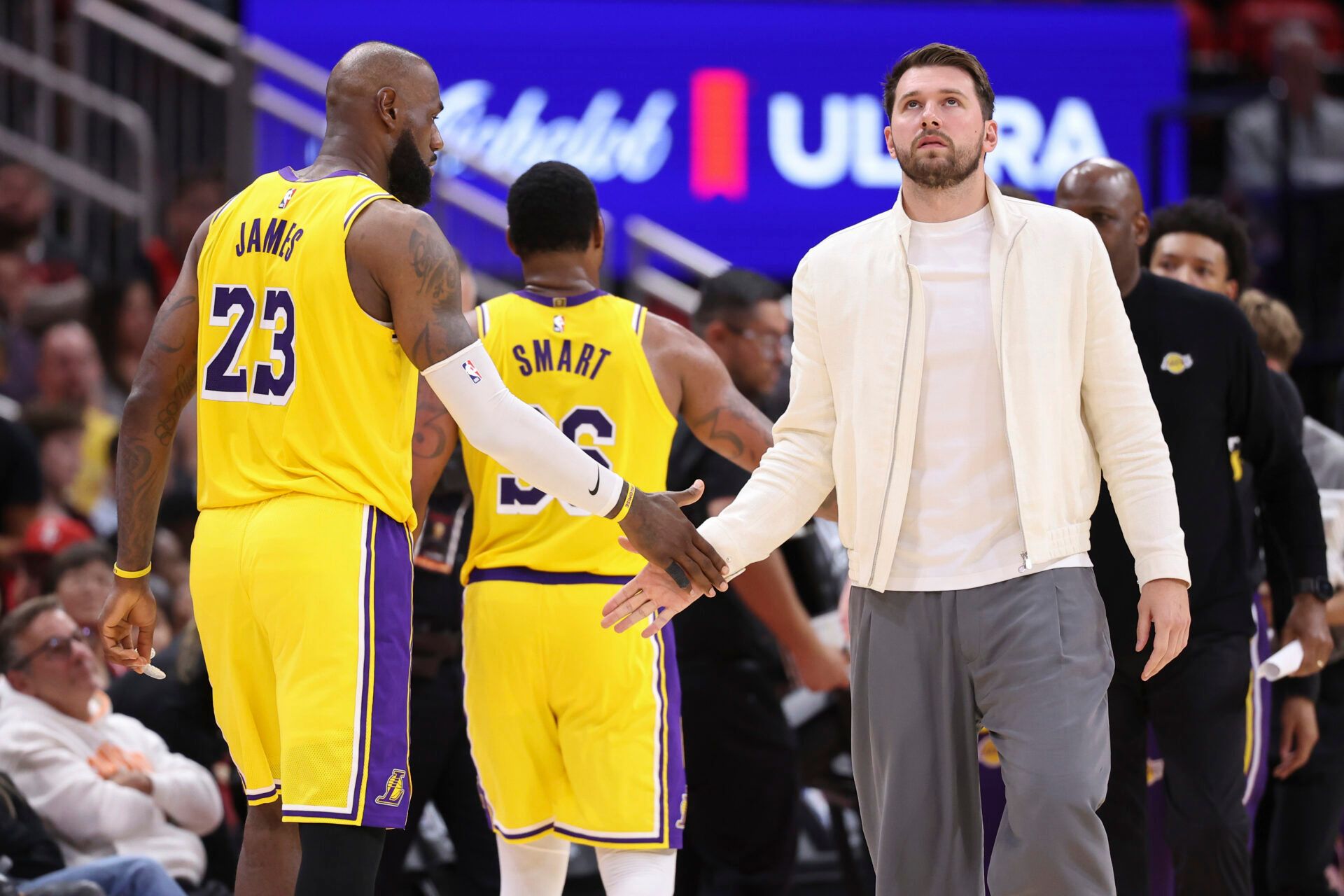 Los Angeles Lakers forward/guard Luka Doncic shakes hands with forward LeBron James (23) during the third quarter against the Houston Rockets during game three of the first round of the 2026 NBA Playoffs at Toyota Center.