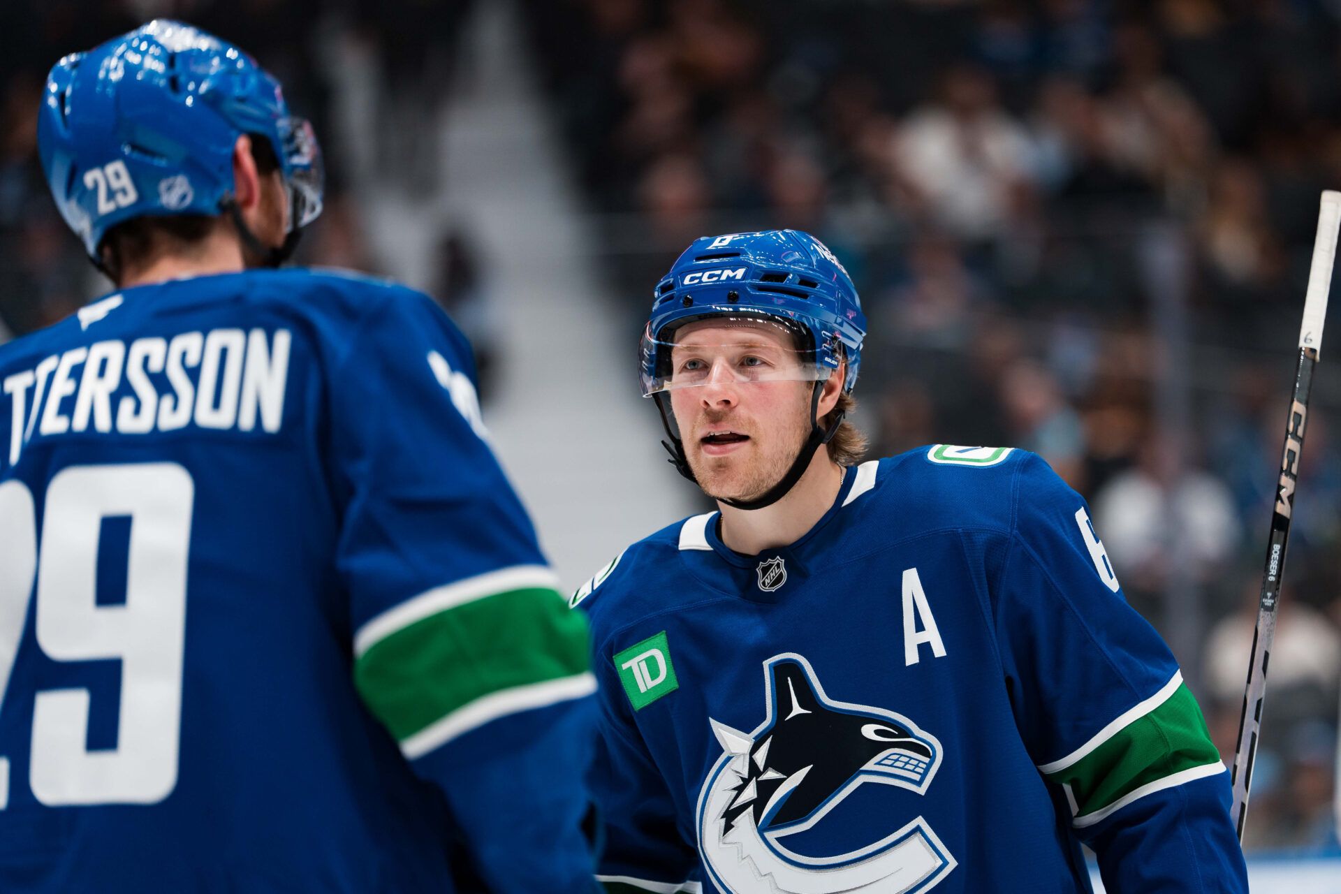 Vancouver Canucks forward Brock Boeser (6) talks with defenseman Marcus Pettersson (29) at Rogers Arena.