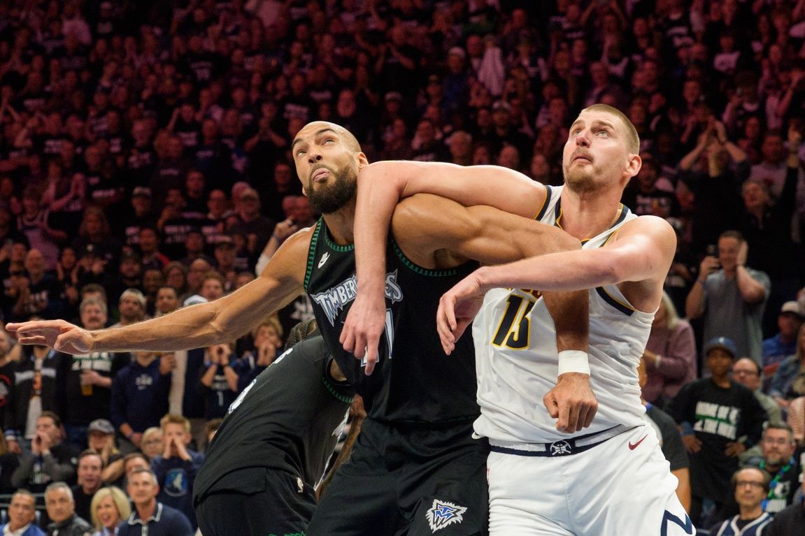 Minnesota Timberwolves center Rudy Gobert (27) and Denver Nuggets center Nikola Jokic (15) position themselves for a rebound in the fourth quarter at Target Center.