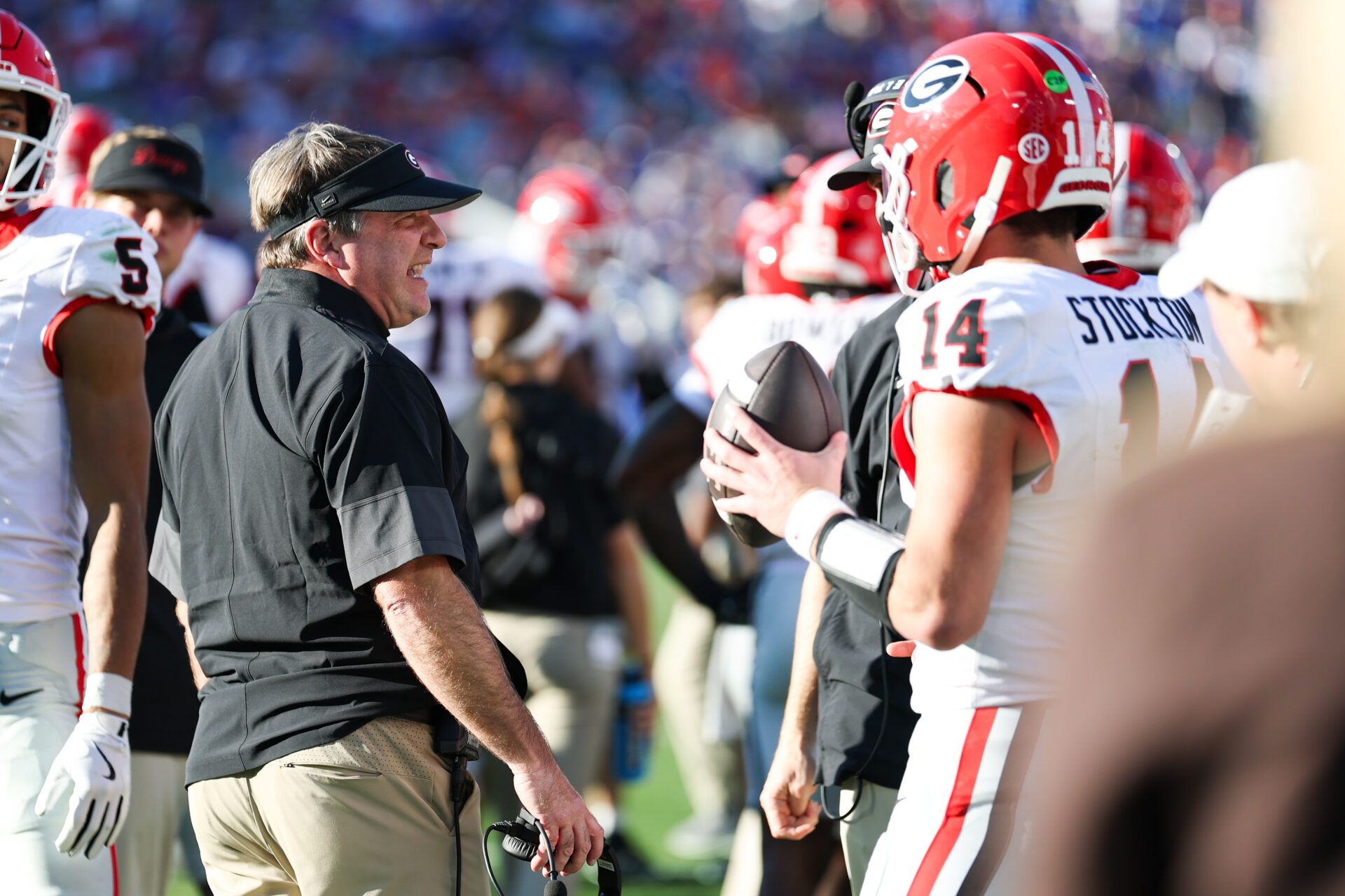 Georgia Bulldogs head coach Kirby Smart speaks with quarterback Gunner Stockton (14) during the second quarter against the Florida Gators at EverBank Stadium.