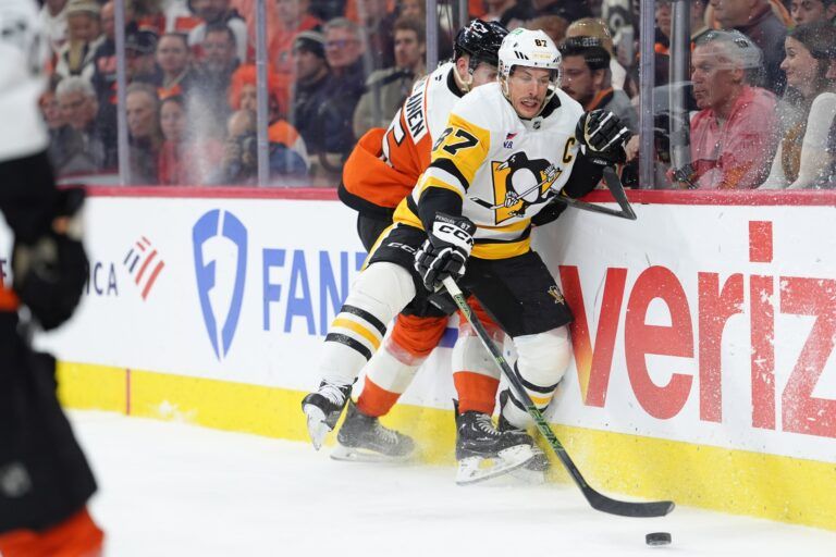 Pittsburgh Penguins center Sidney Crosby (87) reaches for the puck against Philadelphia Flyers defenseman Rasmus Ristolainen (55) in the second period in game six of the first round of the 2026 Stanley Cup Playoffs at Xfinity Mobile Arena.